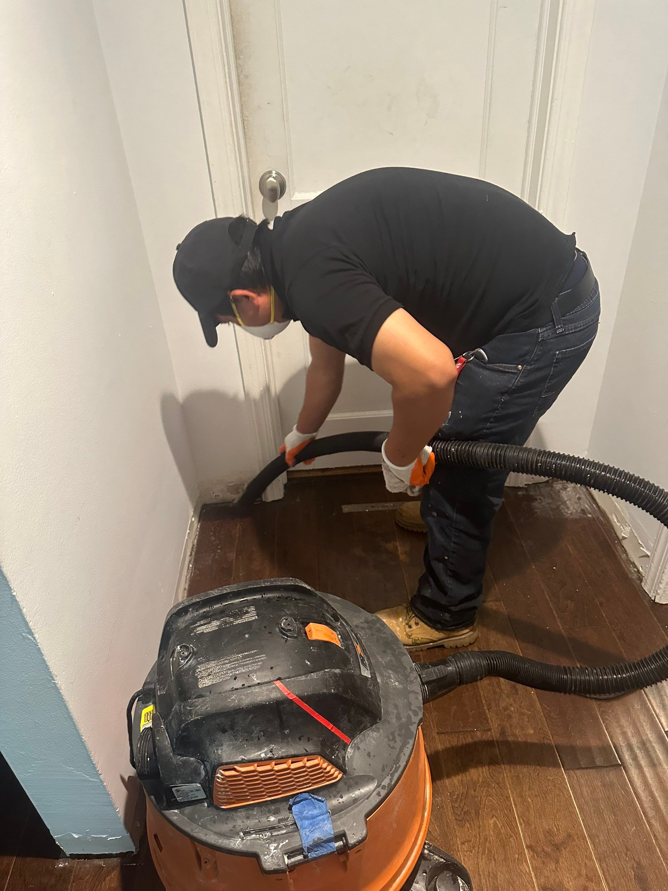 Mid-stage drying phase showing equipment placement and flooring preparation during Alexandria mold remediation work.