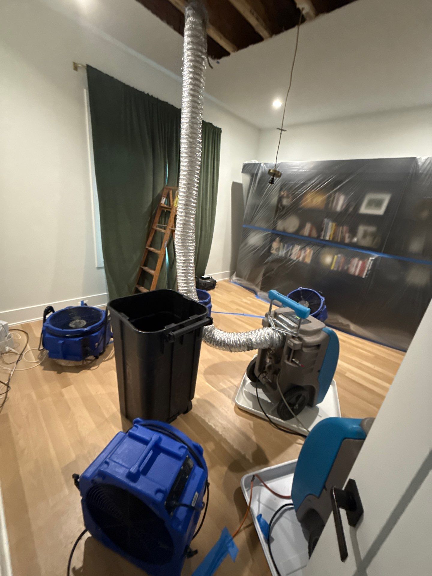Moisture monitoring and equipment placement mid-restoration to manage ceiling and framing drying.