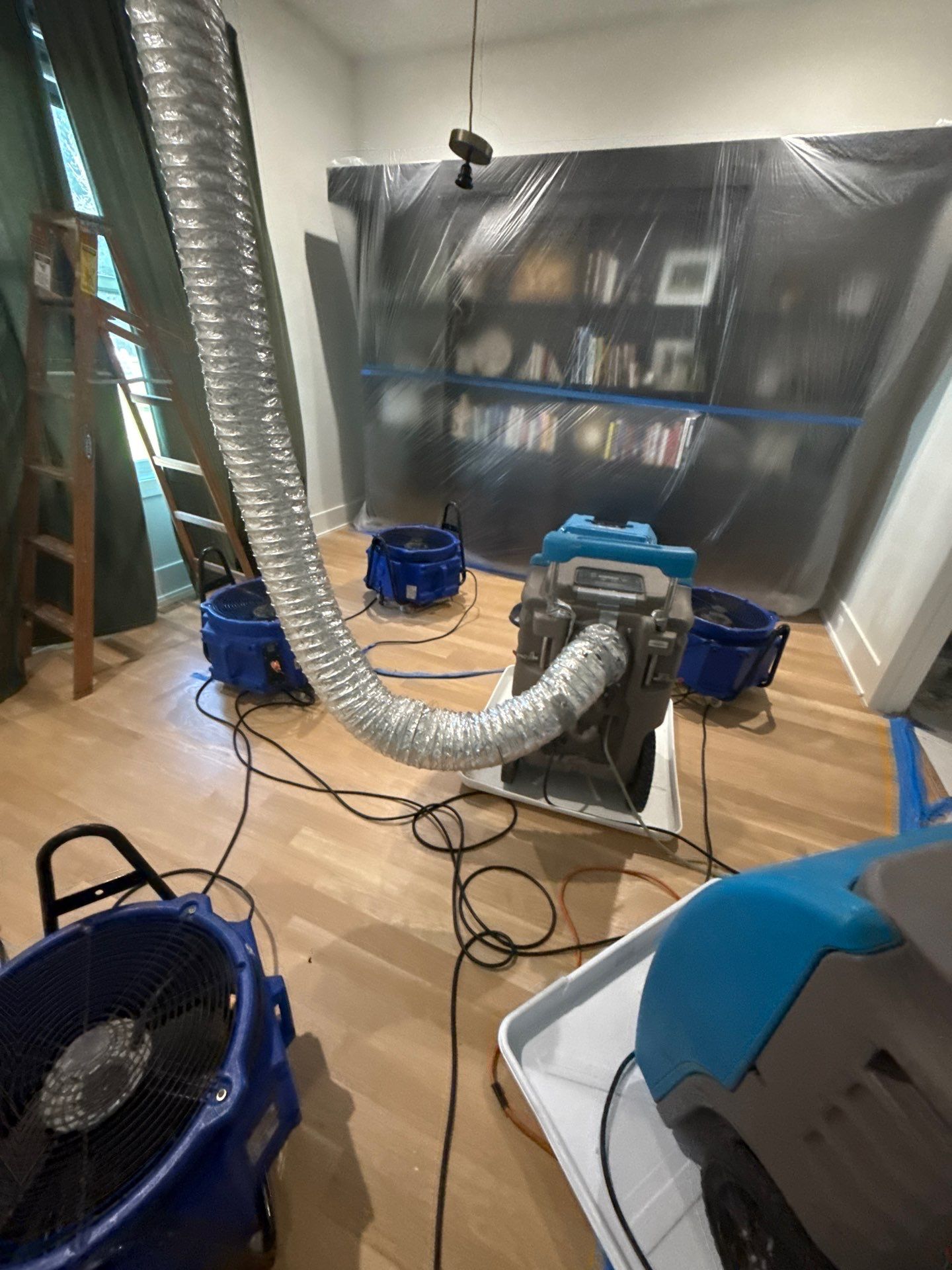 Continued dehumidification phase with equipment staged for structural water damage drying.