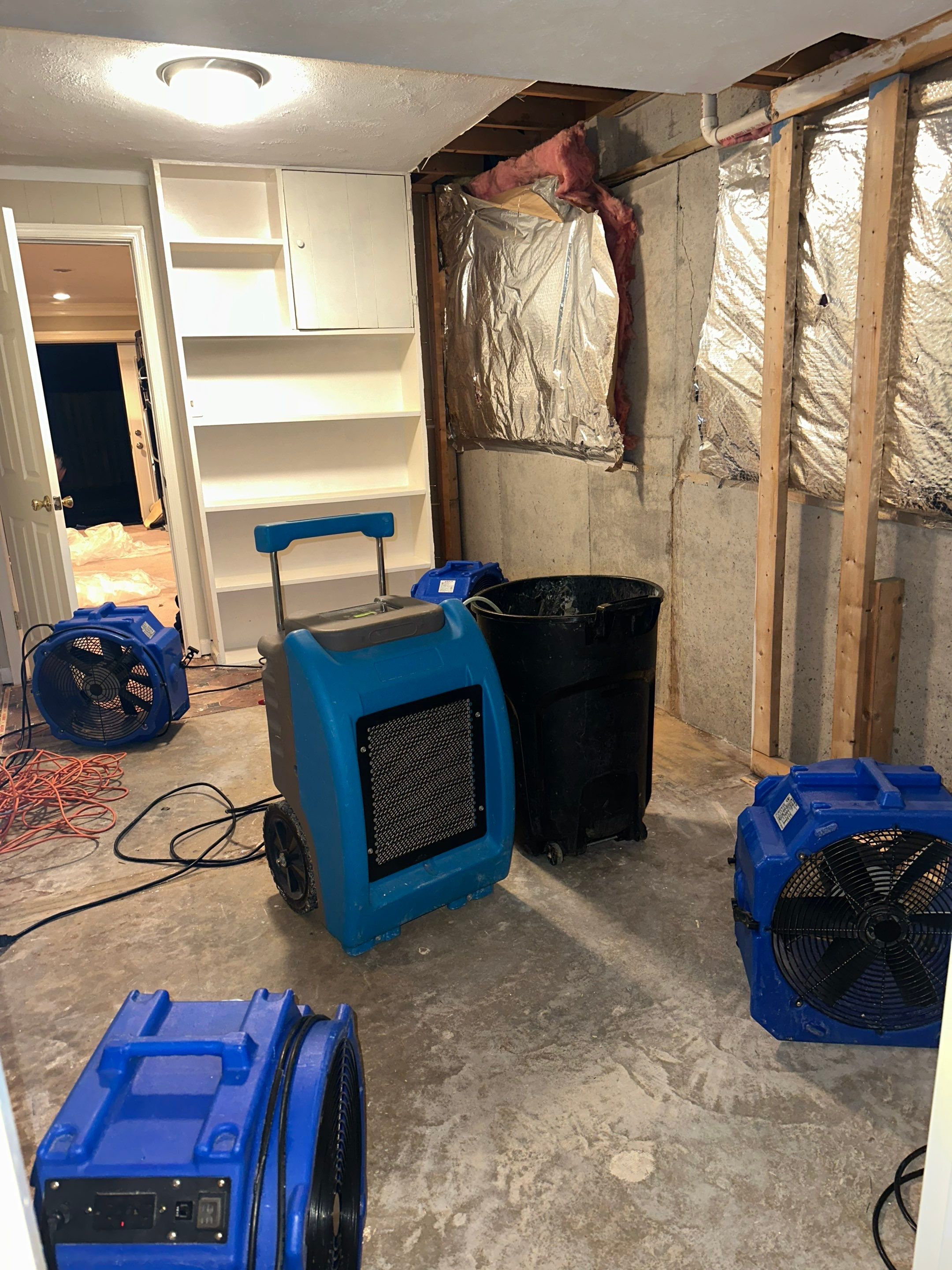 Final-stage water damage restoration in Oakton with drying equipment and sanitization work nearing completion.