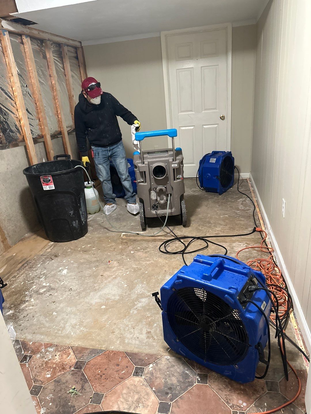 Mid-stage drying setup showing multiple dehumidification units working to extract moisture from affected areas.