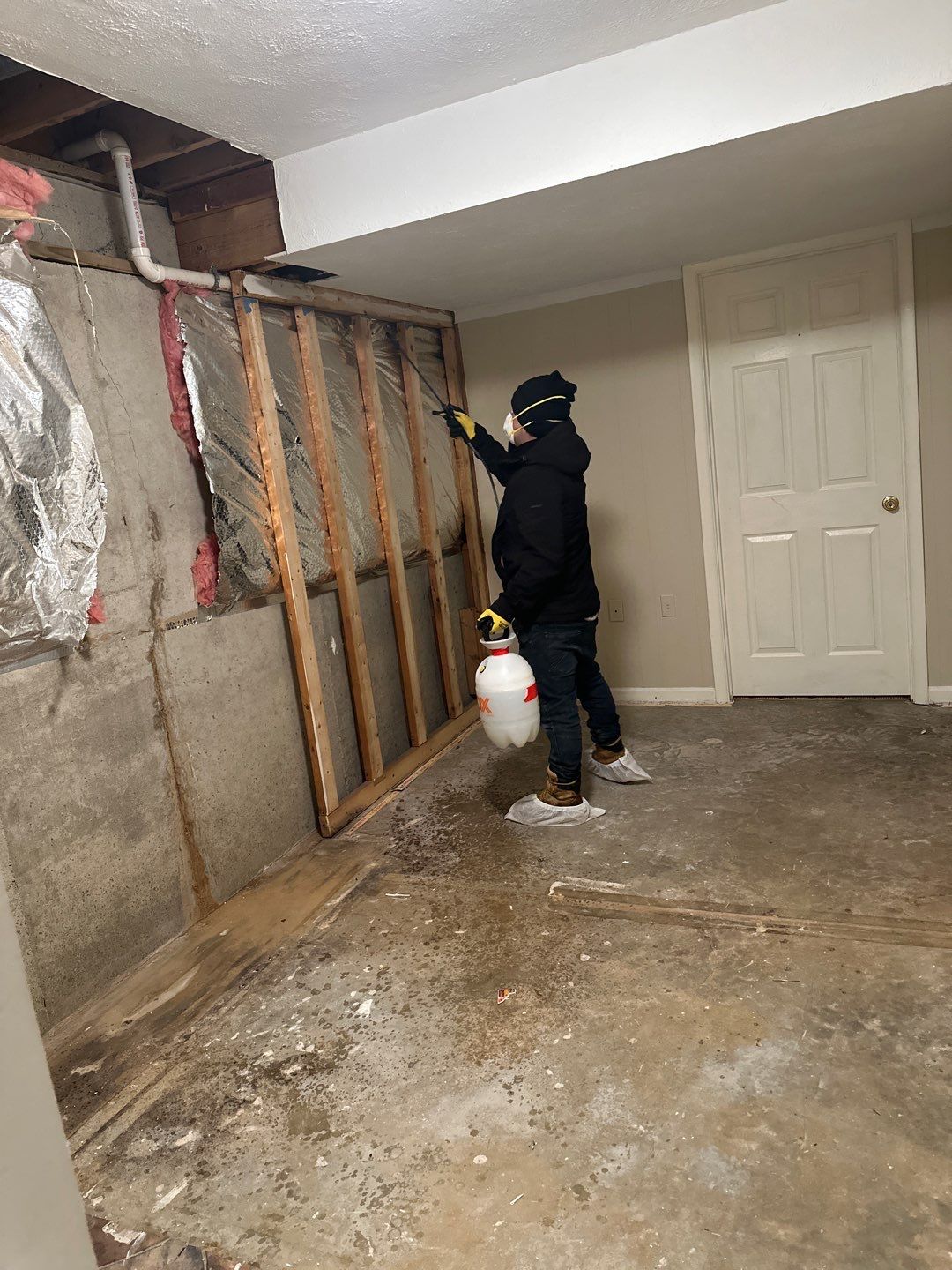 Advanced drying stage with dehumidifiers and sanitizing measures in progress across the restoration space.