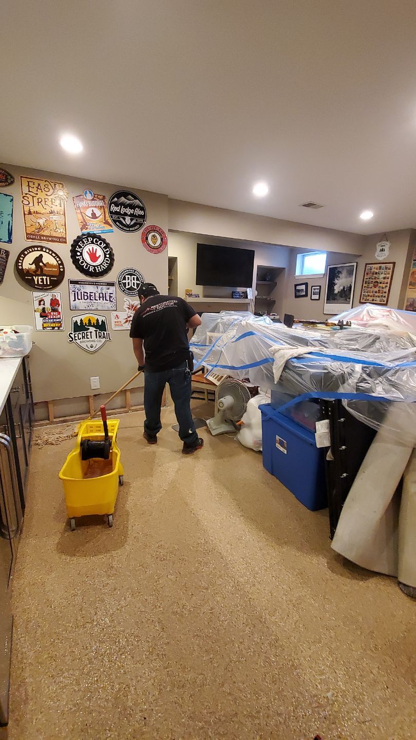Standing water extraction underway in Great Falls water damage restoration, extractors removing pooled water from flooded interior.