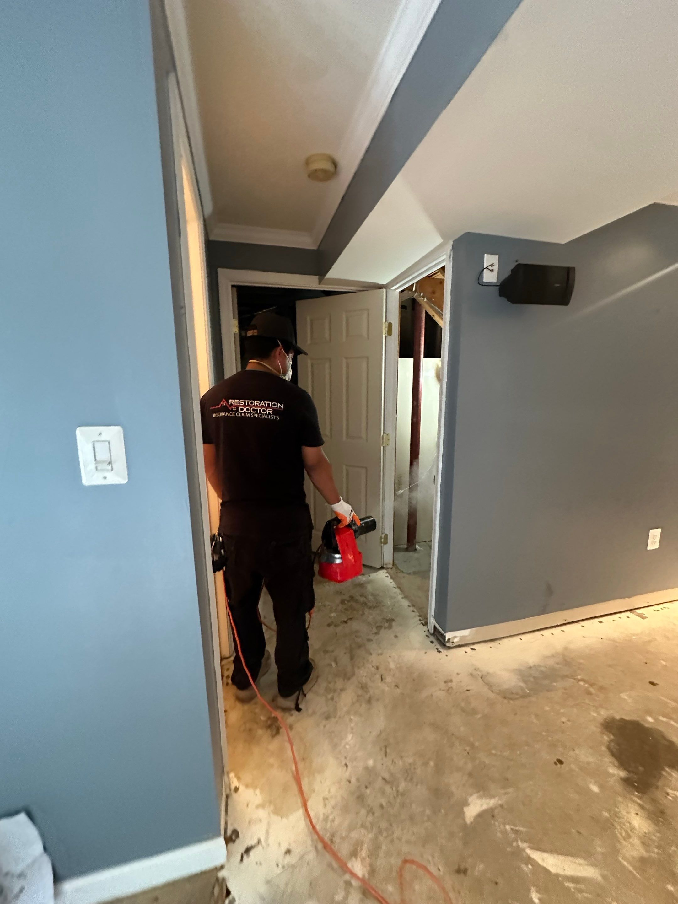 Mid-stage drying setup showing dehumidifiers and air movers managing moisture extraction from affected areas.
