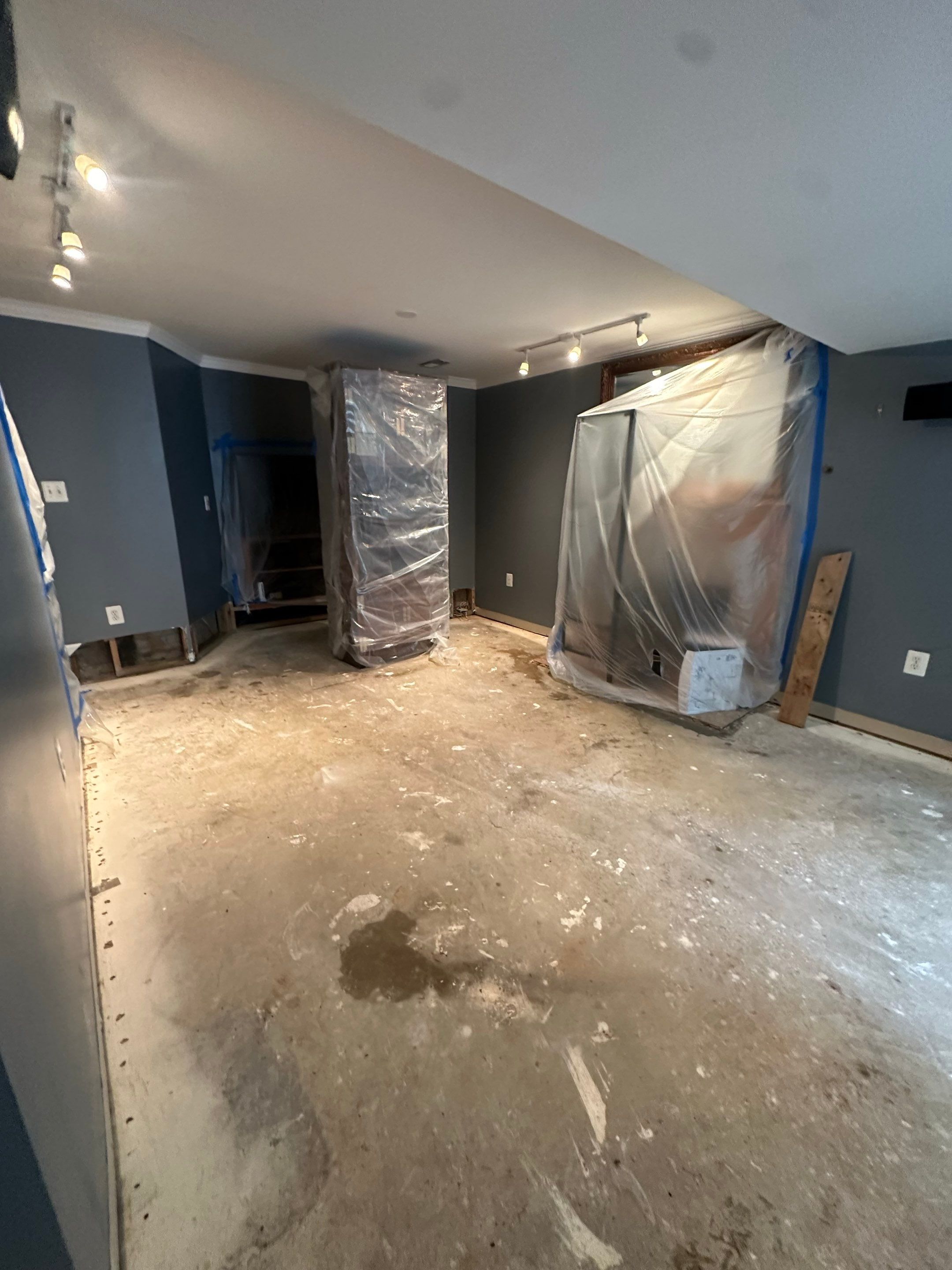 Advanced drying phase with dehumidification systems working to restore structural integrity before flooring remediation.