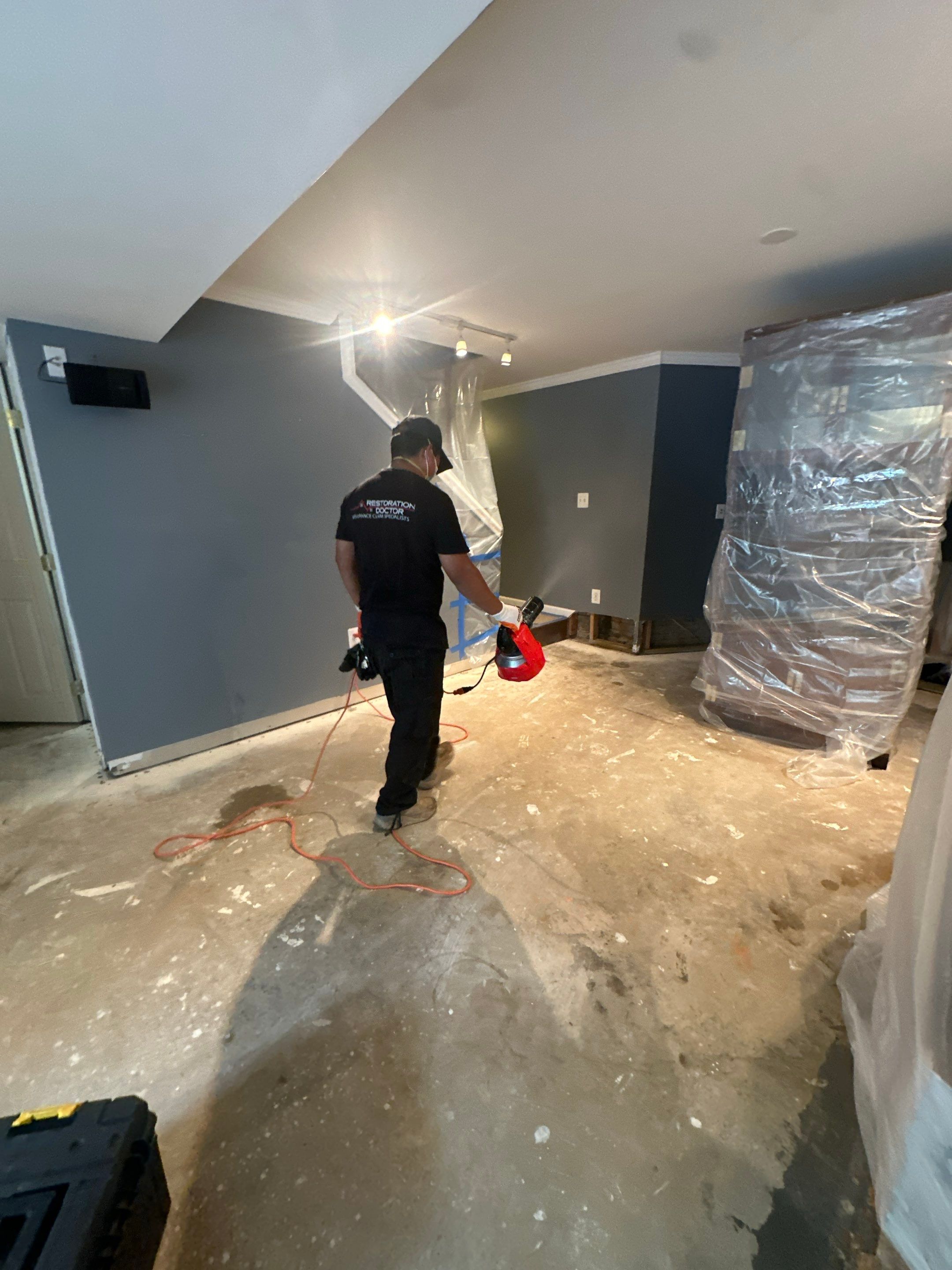 Water-damaged carpet and flooring in Woodbridge home with dehumidification equipment positioned for structural drying.