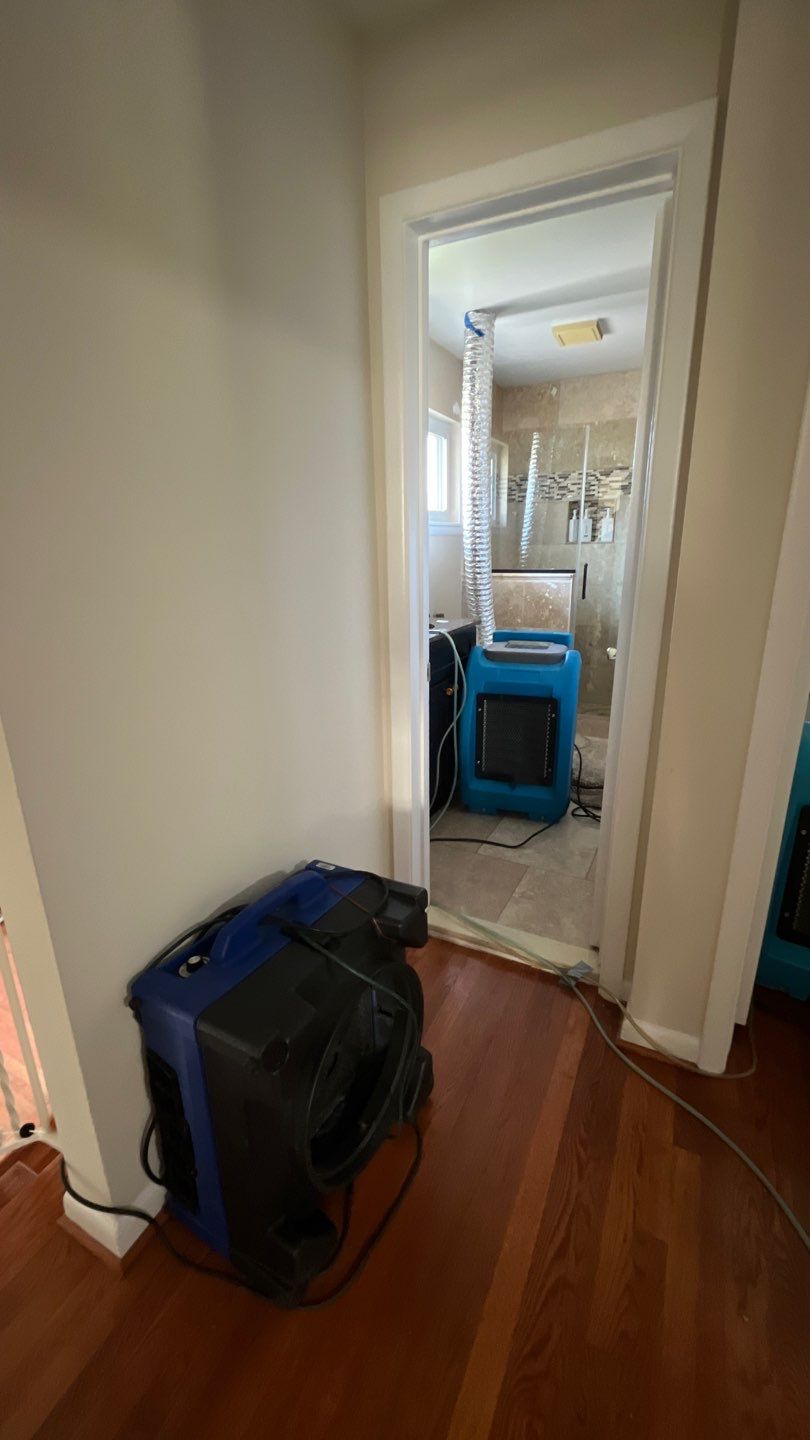 Water damage restoration underway in McLean with dehumidification equipment deployed and ceiling damage visible.