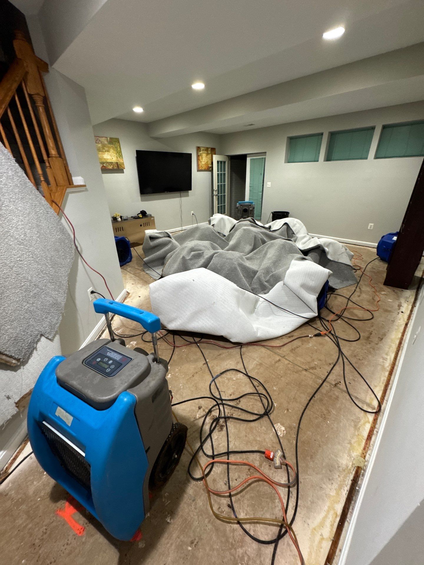 Industrial dehumidifier positioned during mid-stage drying to remove moisture from affected areas.