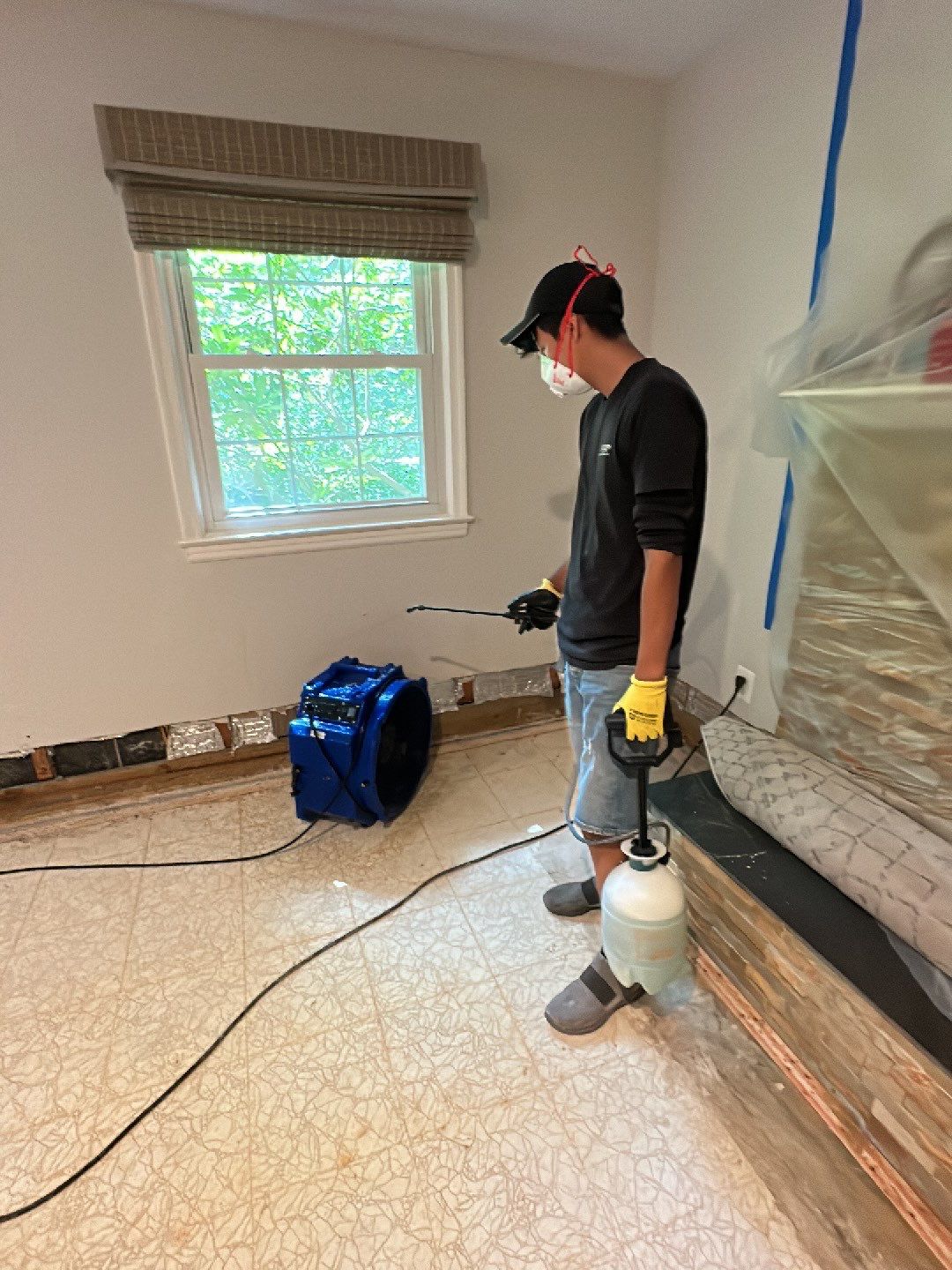 Structural drying in progress with multiple dehumidifiers extracting moisture from walls and flooring.