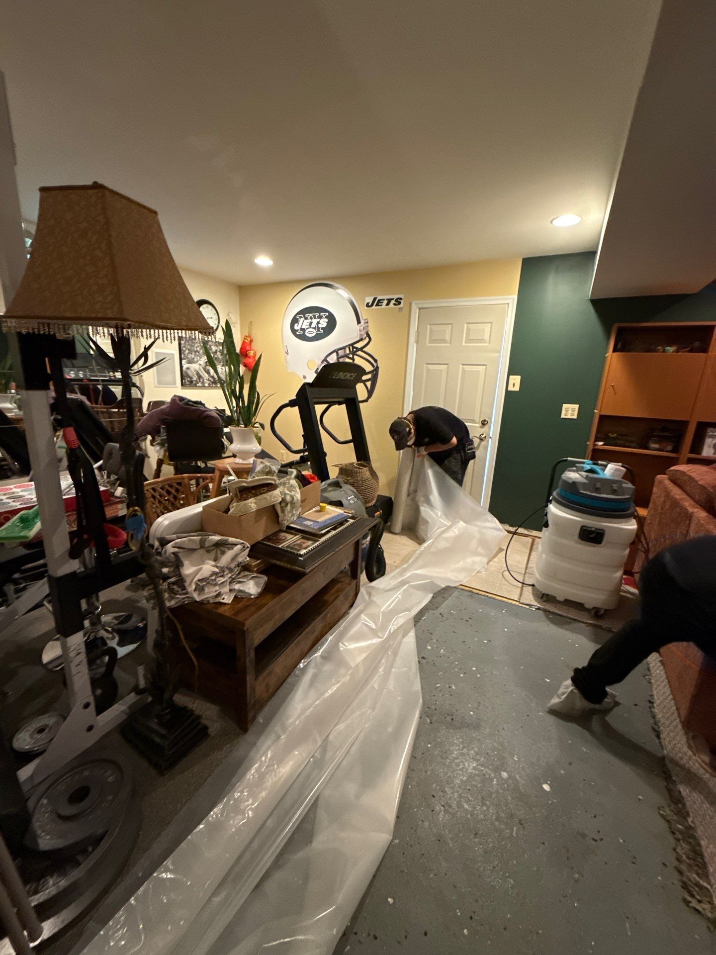 Wall section removal in progress, damaged drywall and framing staged for replacement as part of restoration scope.