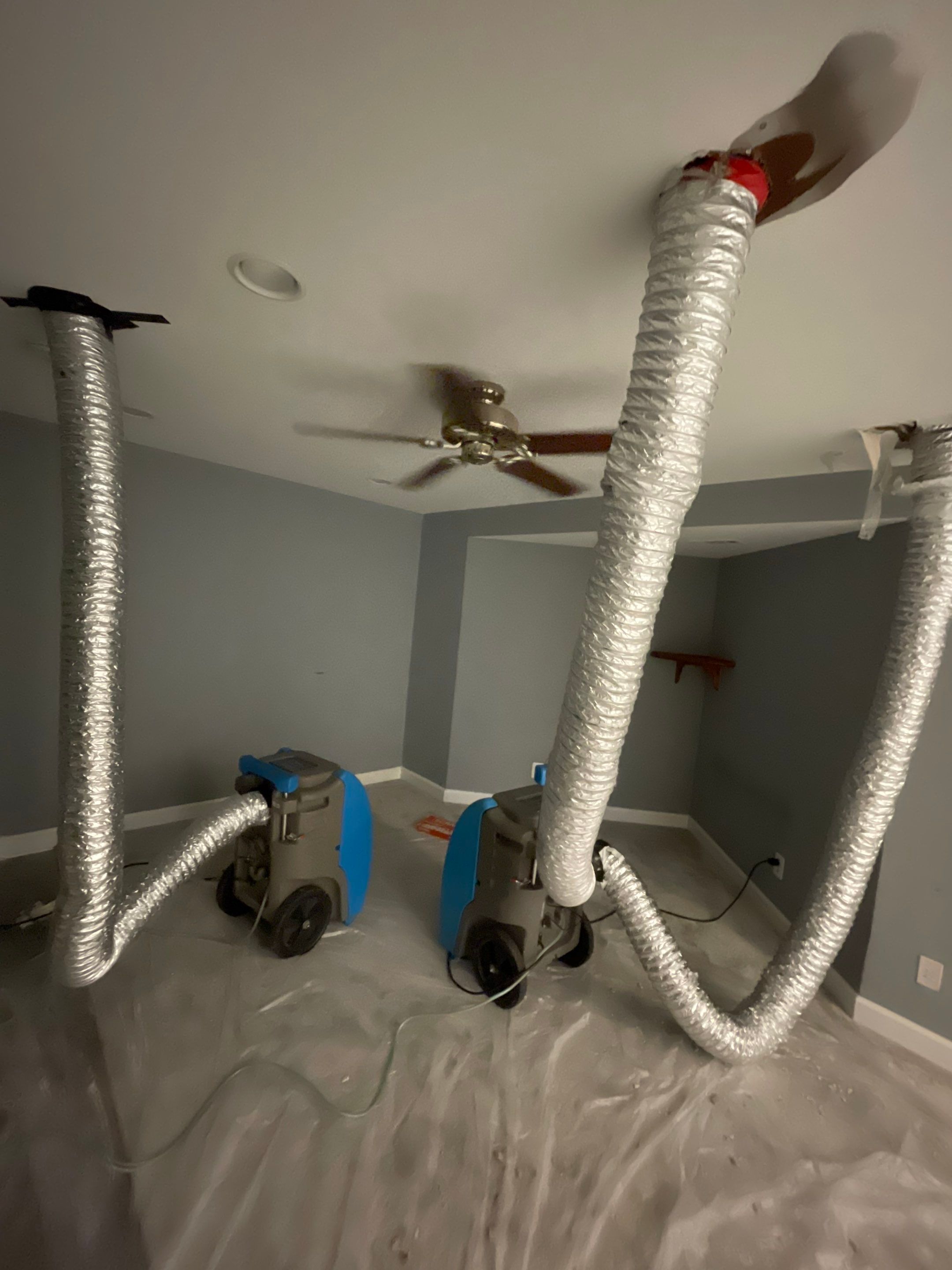 Dehumidification equipment positioned to manage moisture levels in affected Woodbridge home.