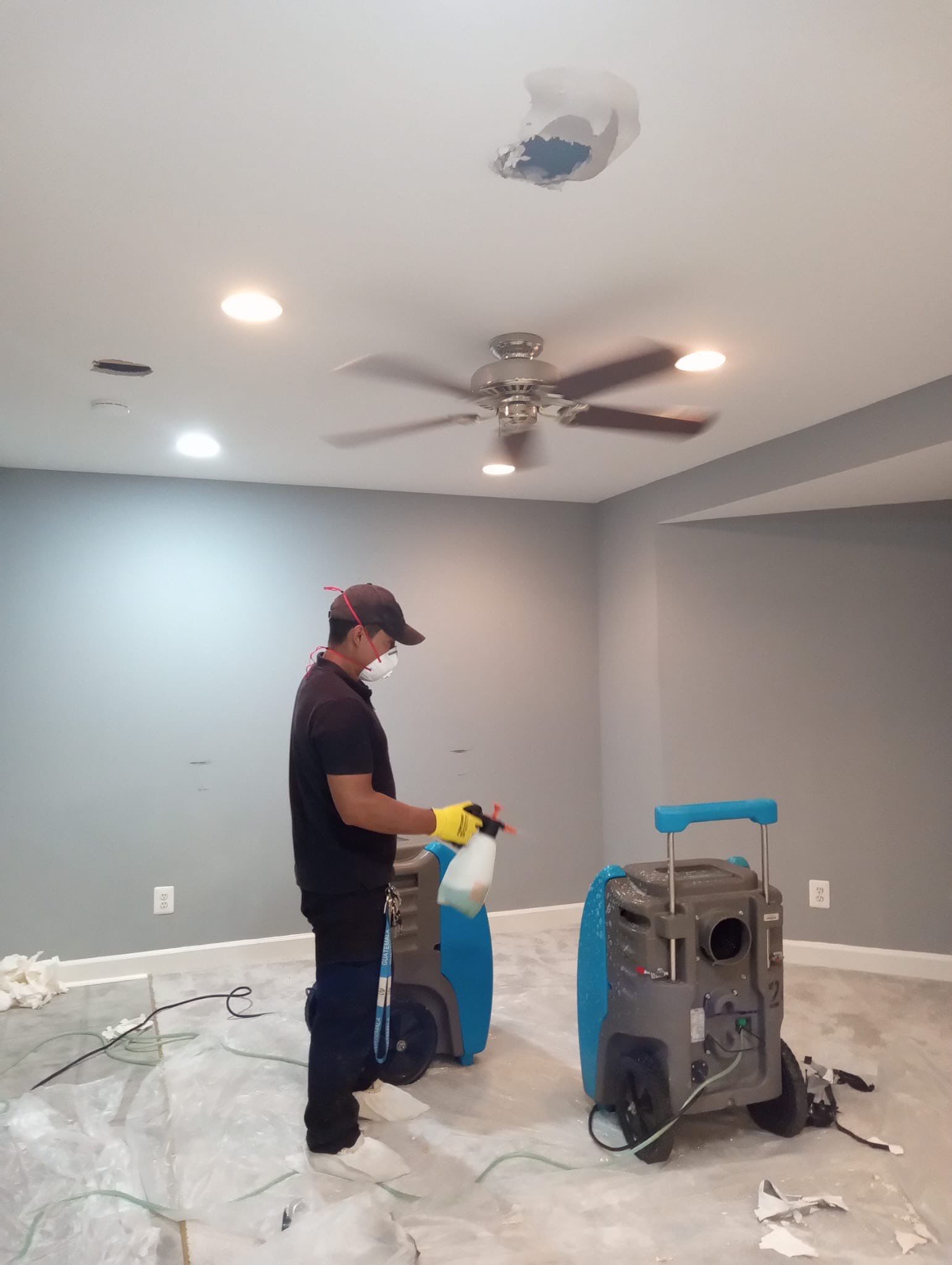 Standing water extraction underway in Woodbridge water damage restoration, initial assessment phase.
