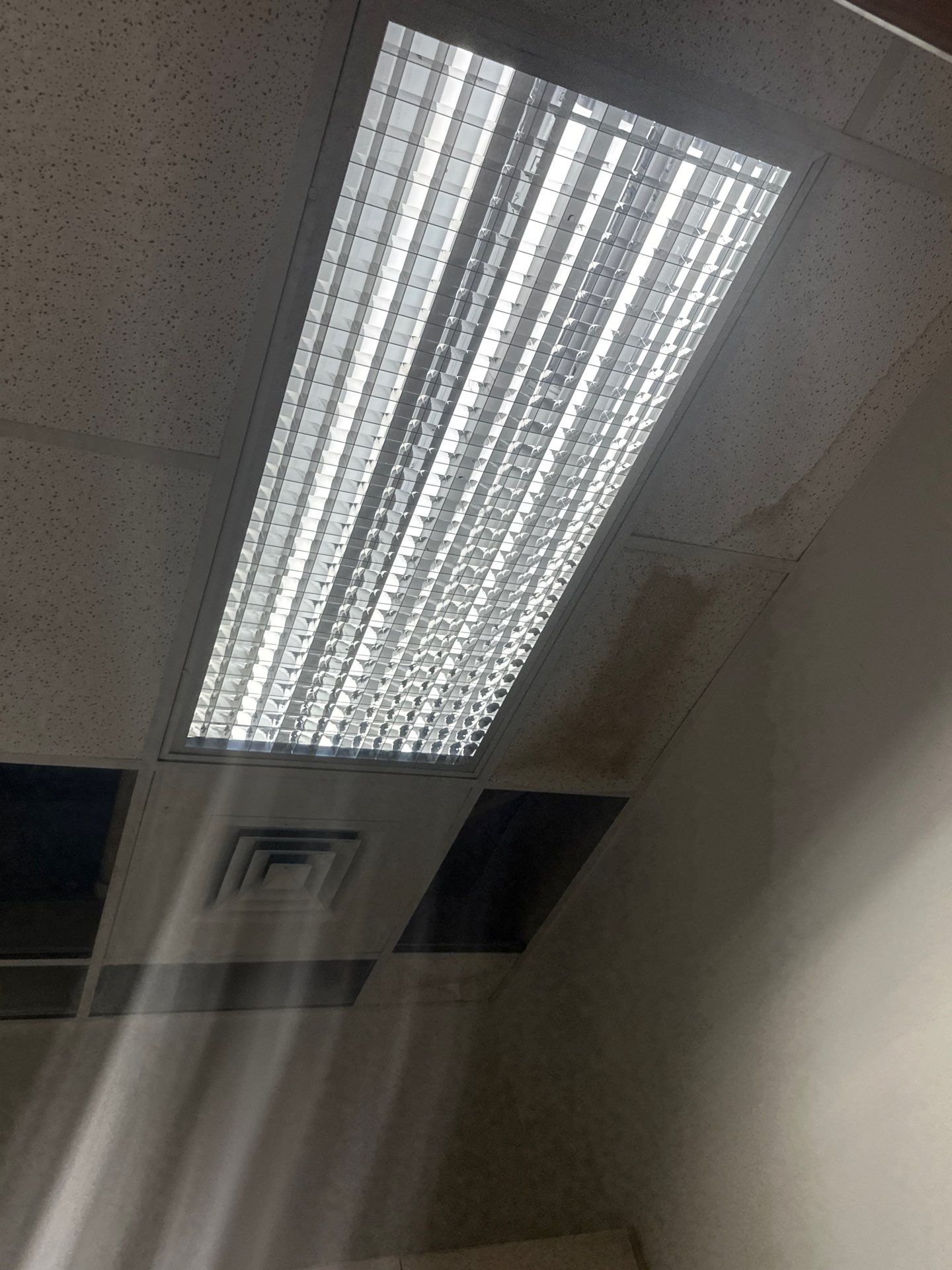 Dehumidifier and air movers running to extract moisture from building materials.