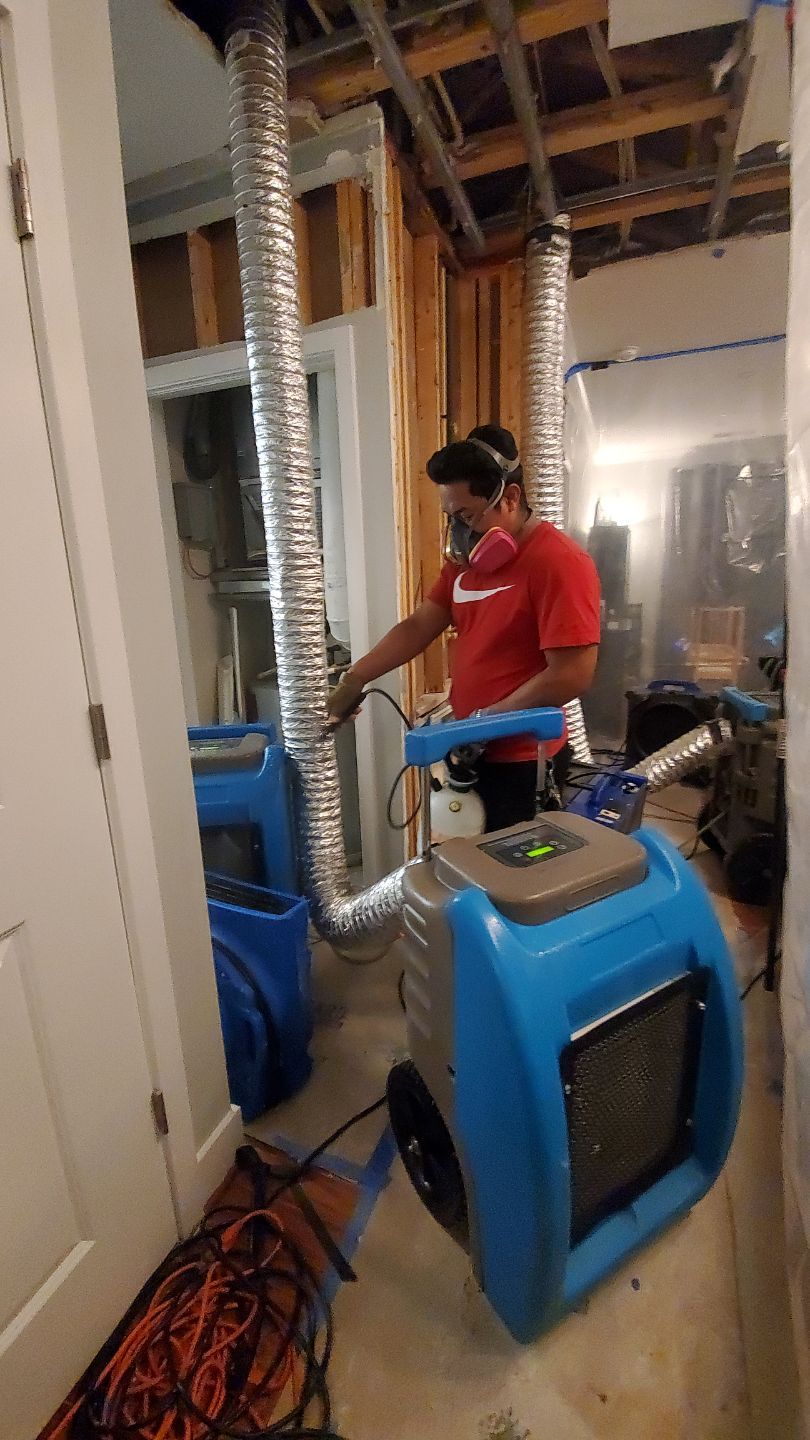 Mid-stage drying phase with dehumidifiers operating and containment maintained to isolate affected zone.