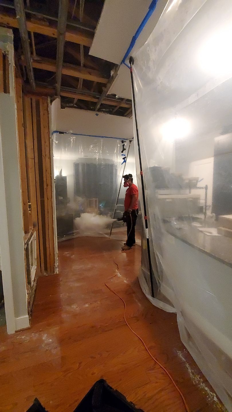 Thermal imaging camera documenting moisture patterns across wall and structural surfaces during water restoration process.