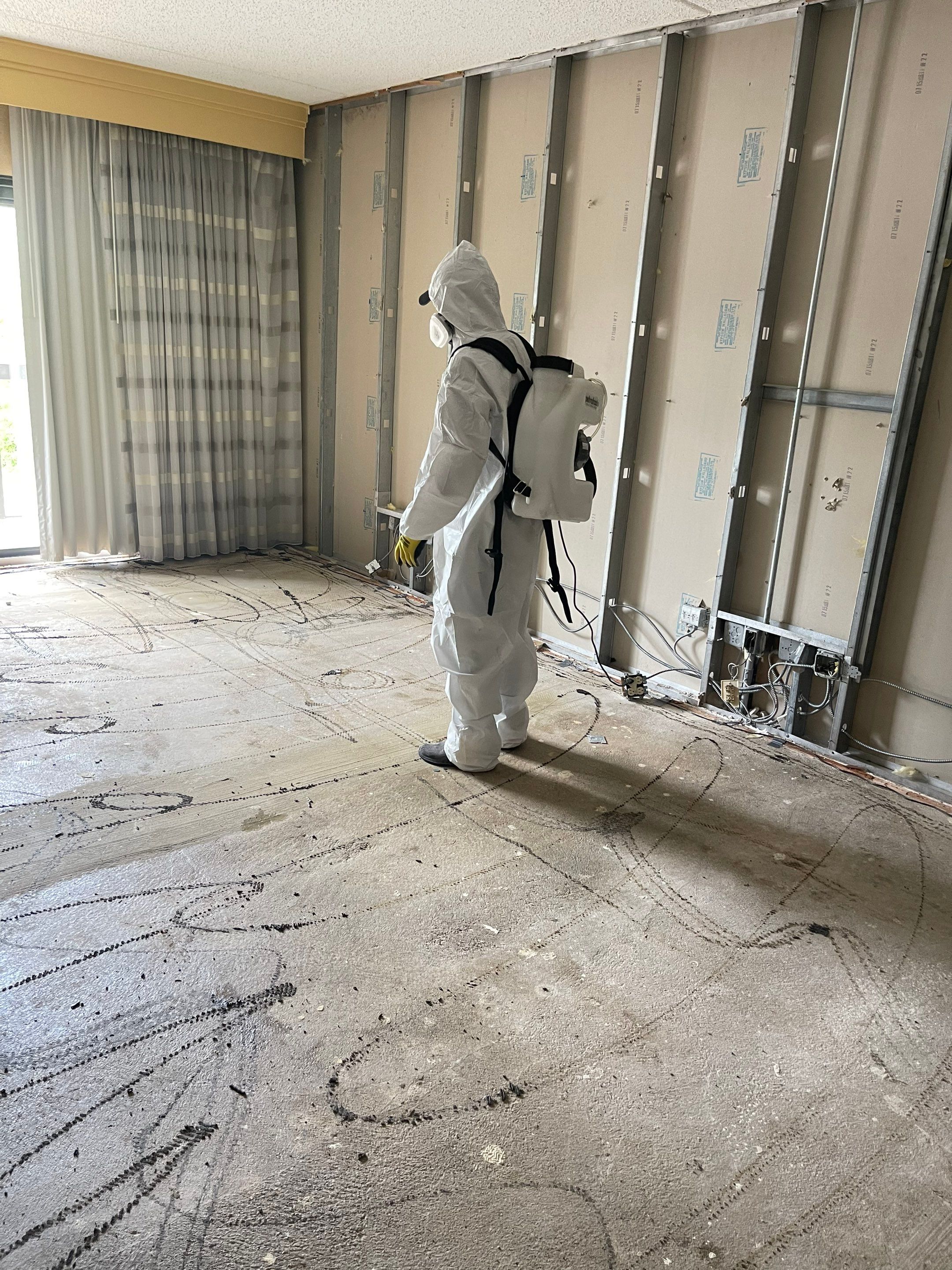 Structural drying in progress with multiple dehumidifiers and air movers deployed throughout the work area.