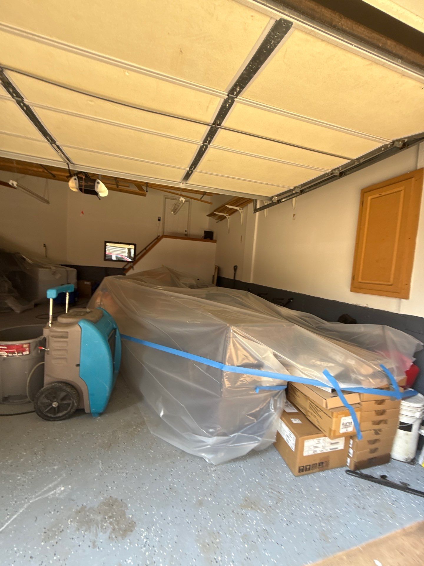 Dehumidifiers and air movers positioned for structural drying phase of water damage restoration.