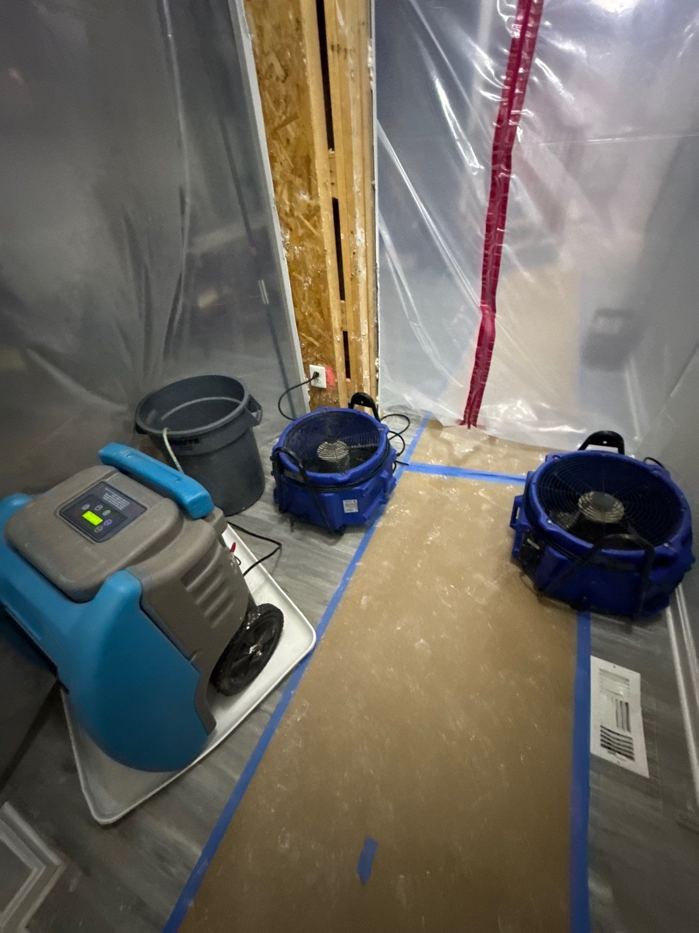 Framing inspection and moisture assessment during mid-stage water restoration in Chantilly.