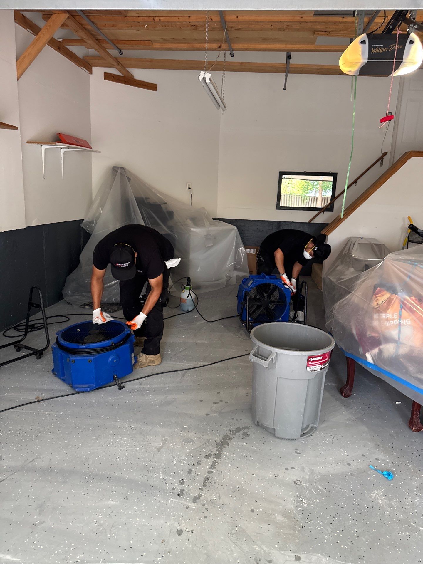 Industrial extractors remove standing water from flooded room during water restoration in Chantilly.
