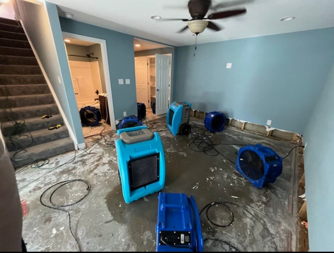 Standing water extraction underway in Stafford home during initial water damage assessment and removal phase.