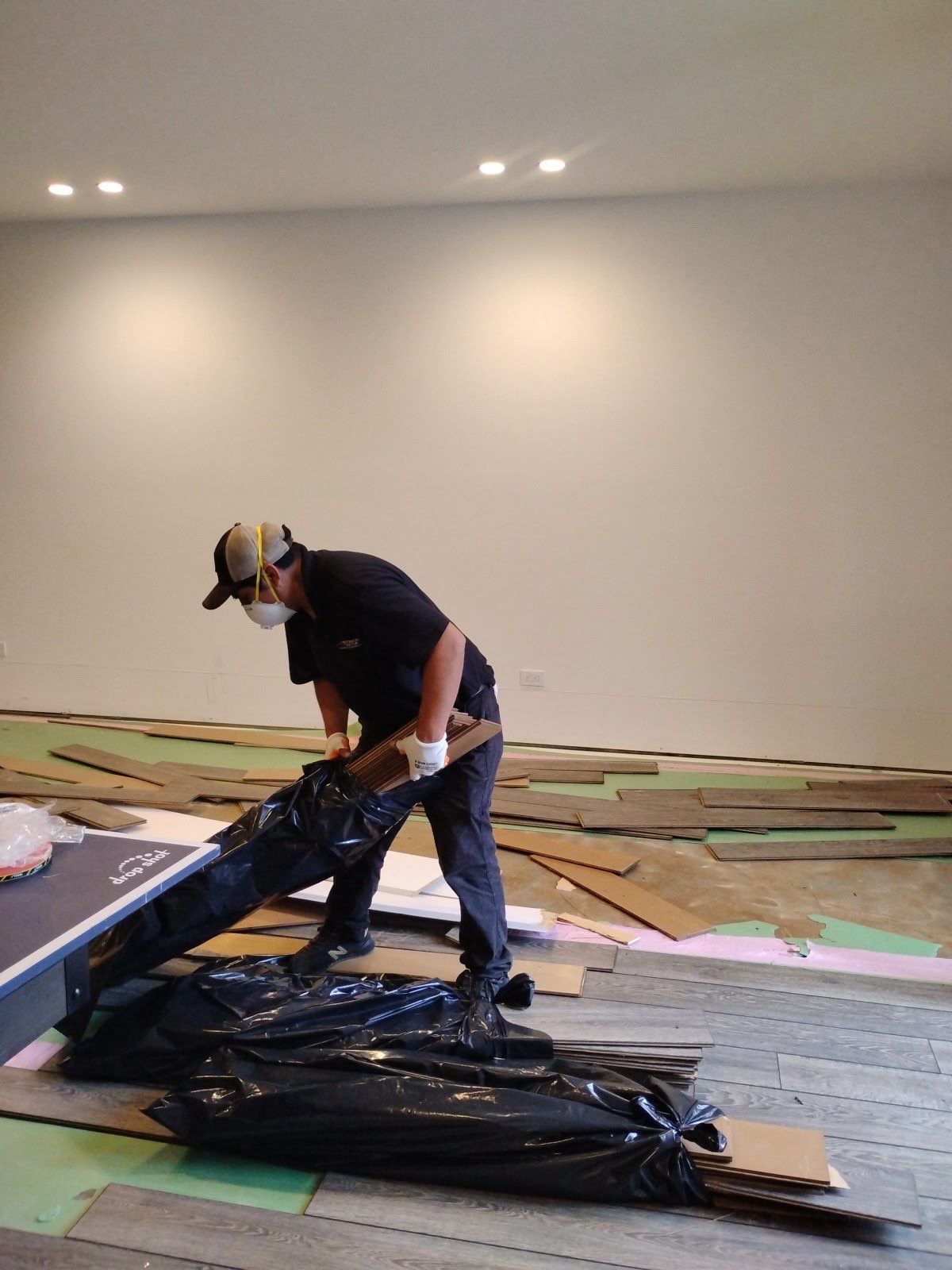Flooring and carpet removal underway as part of Vienna mold remediation containment and sanitization protocol.