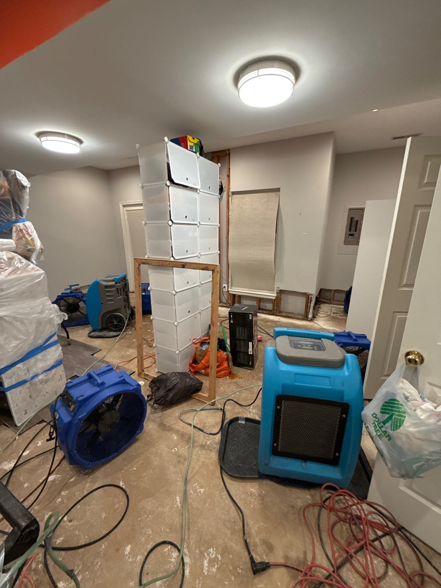 Wet carpet and padding stripped away, exposing subfloor for cleaning and continued drying operations.