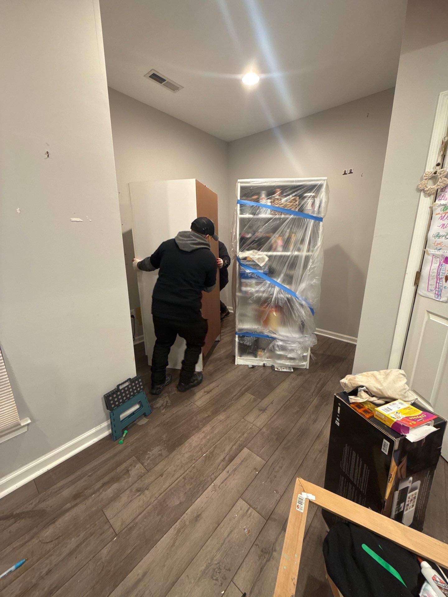 Water-damaged flooring and carpet in Ashburn home marked for removal during initial assessment and structural drying phase.