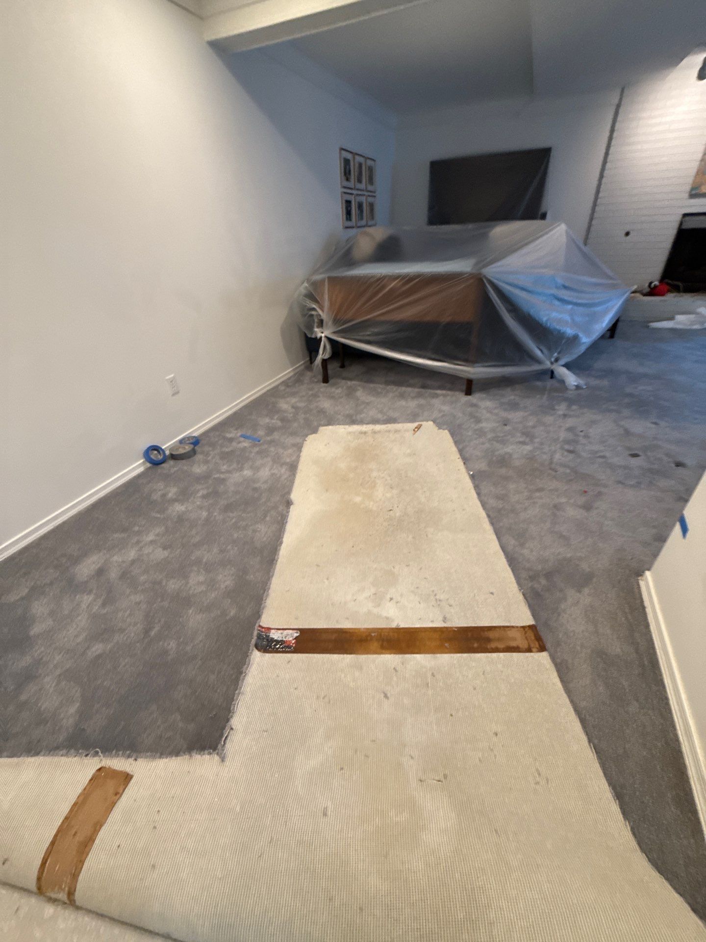 Dehumidifiers and air movers continue drying affected areas during mid-stage mold remediation work.