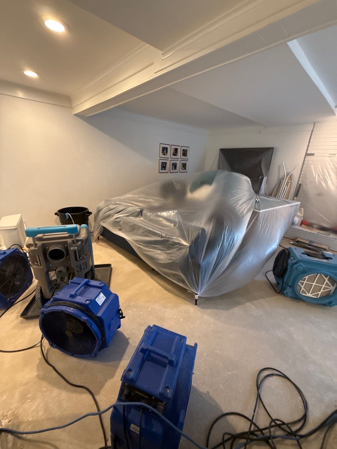 Baseboard removal and replacement underway as structural drying nears completion in McLean home.