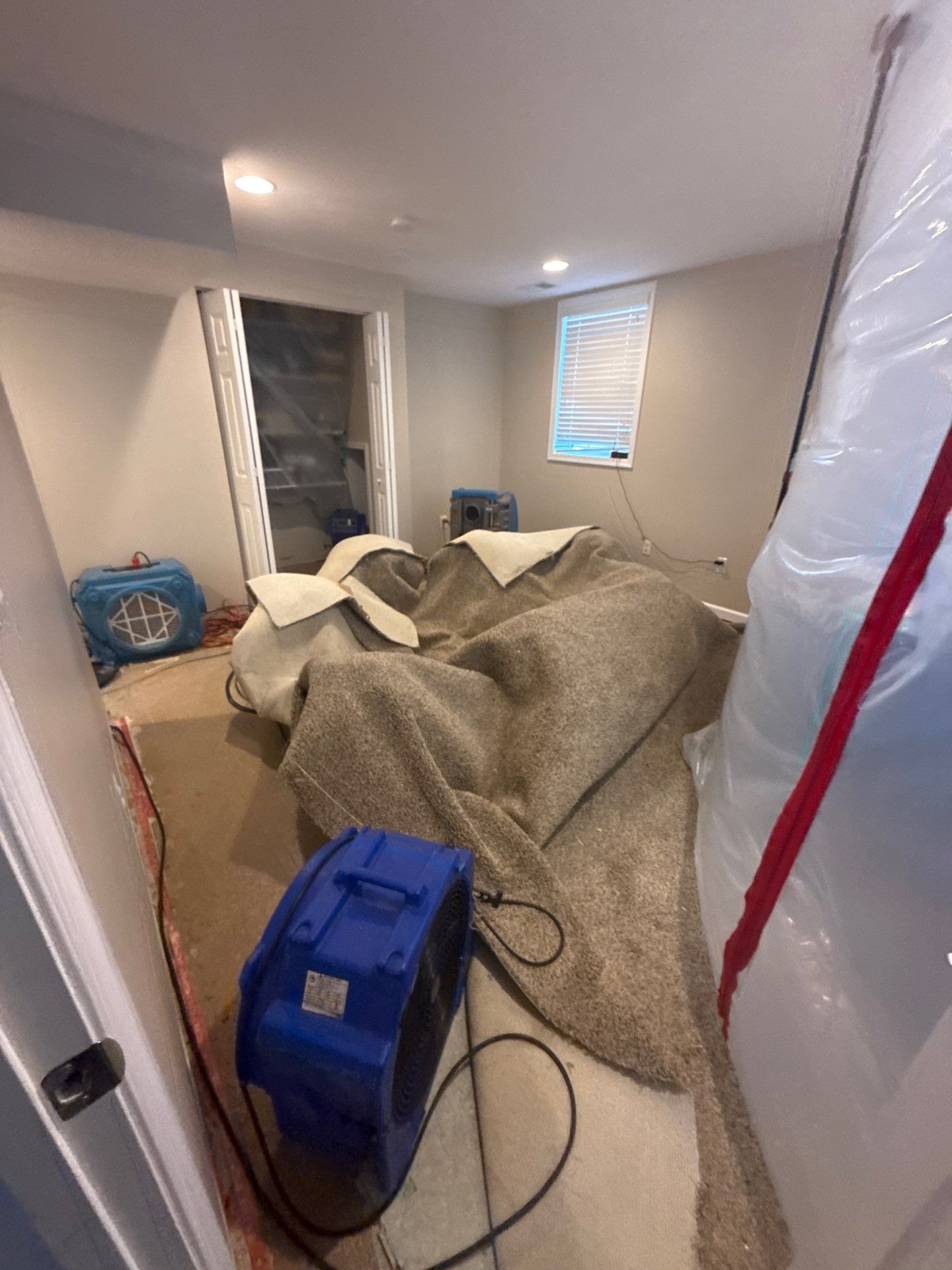 Structural drying equipment positioned within containment zone to manage moisture in affected spaces.