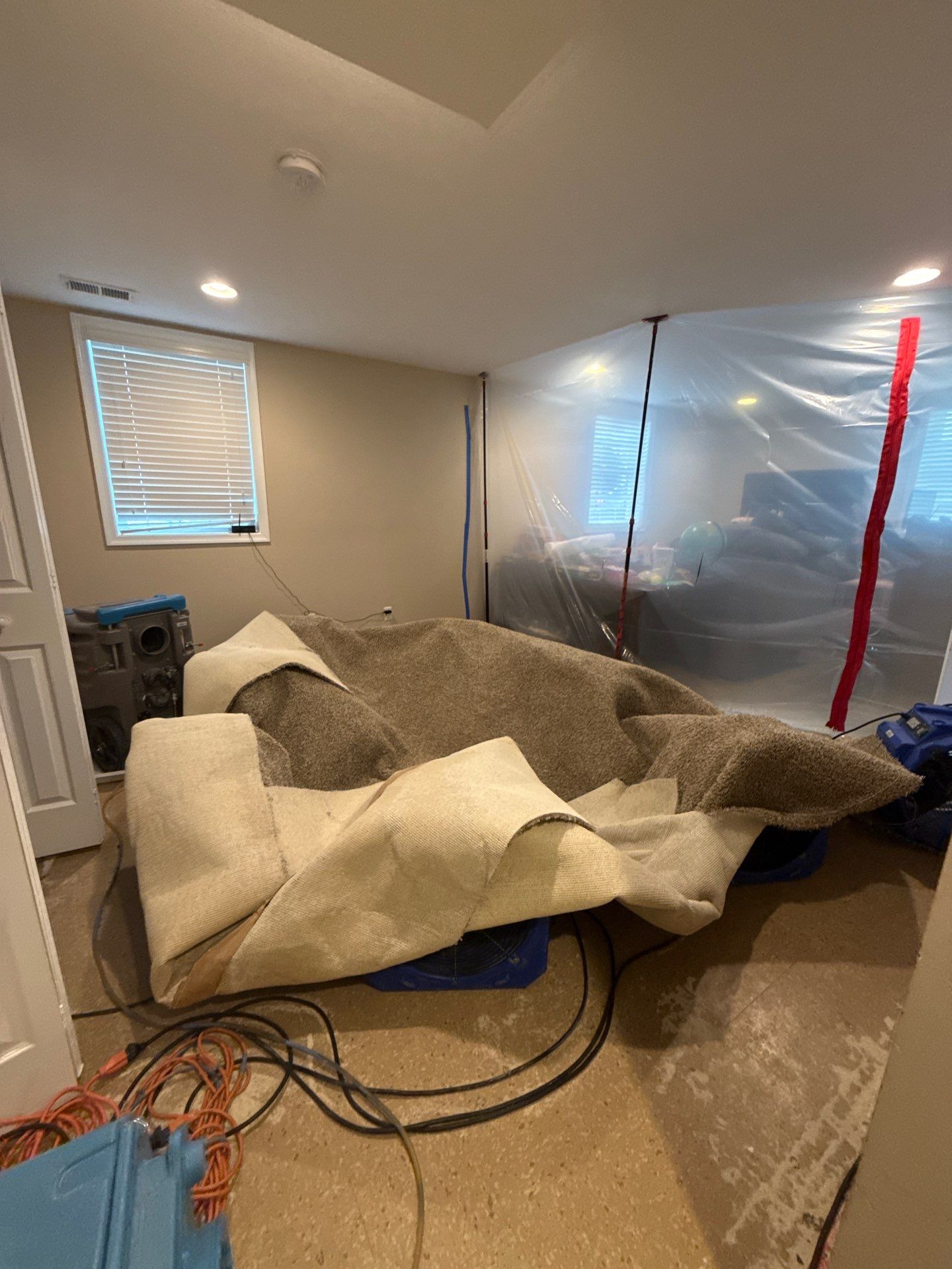 Equipment repositioned for final drying stages as water damage restoration nears completion.