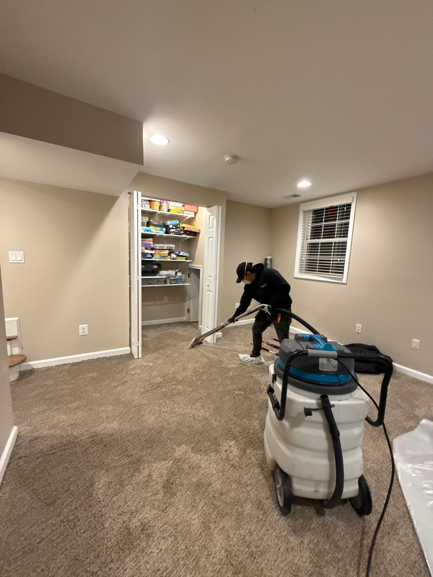 Flooring and carpet removal in progress within contained work area of Alexandria water damage job.