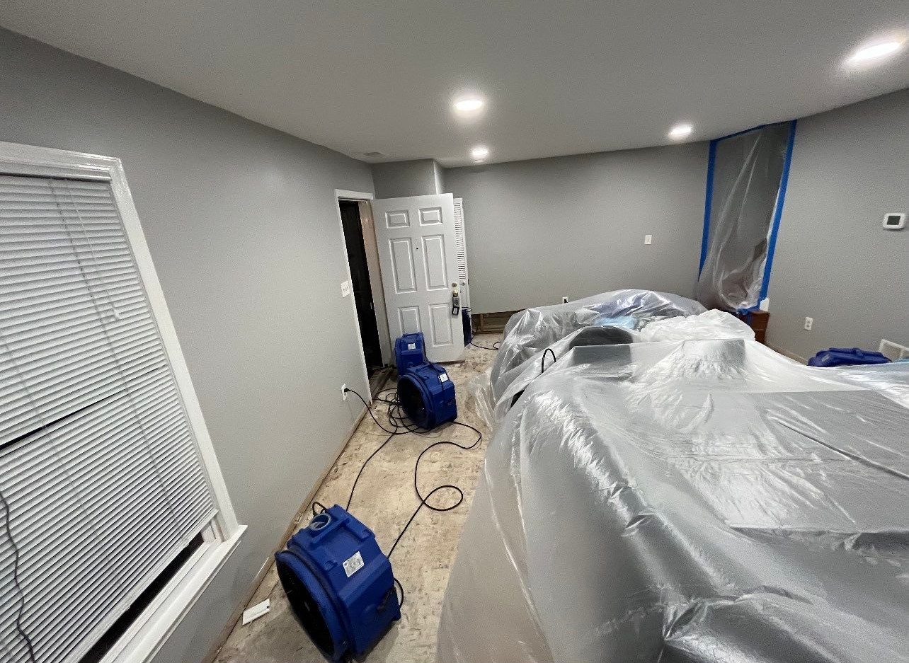 Drying equipment monitoring moisture levels in Arlington home after water damage extraction and remediation.