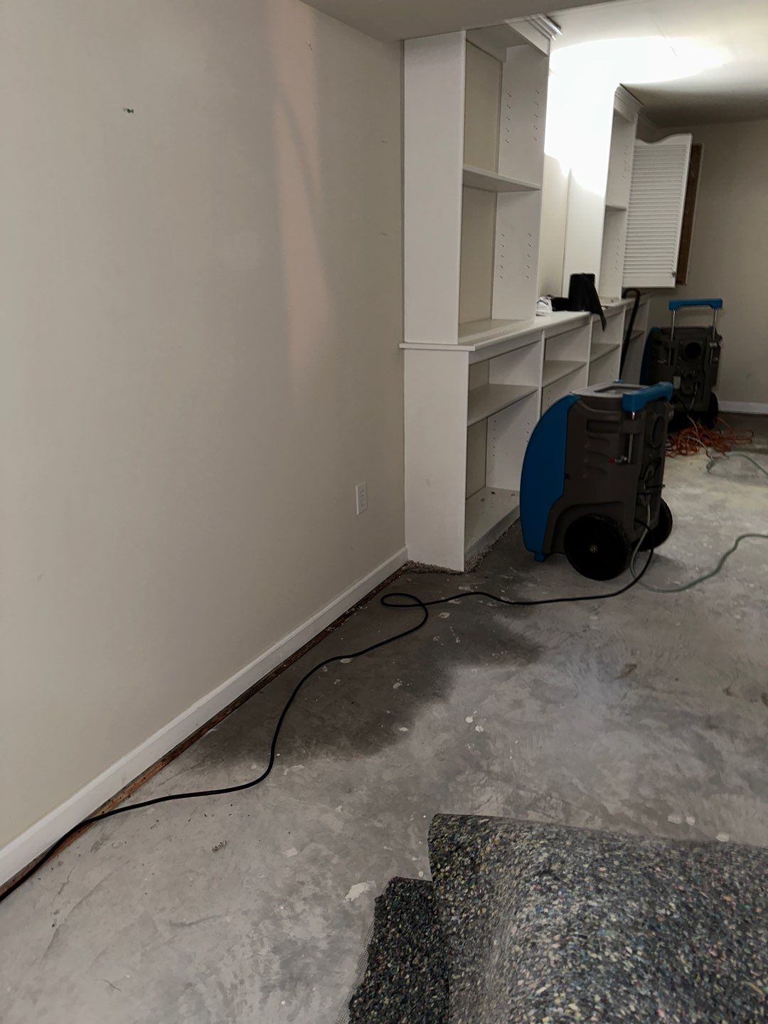Restored flooring and cleared space following Arlington water damage restoration and structural drying completion.