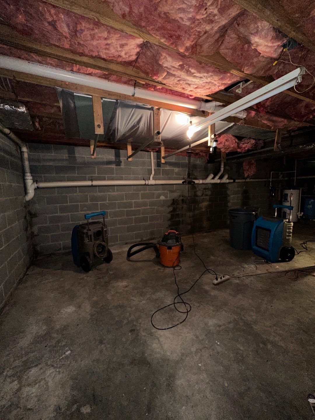 Carpet removal and subflooring exposure in Arlington water damage job, structural drying in progress.