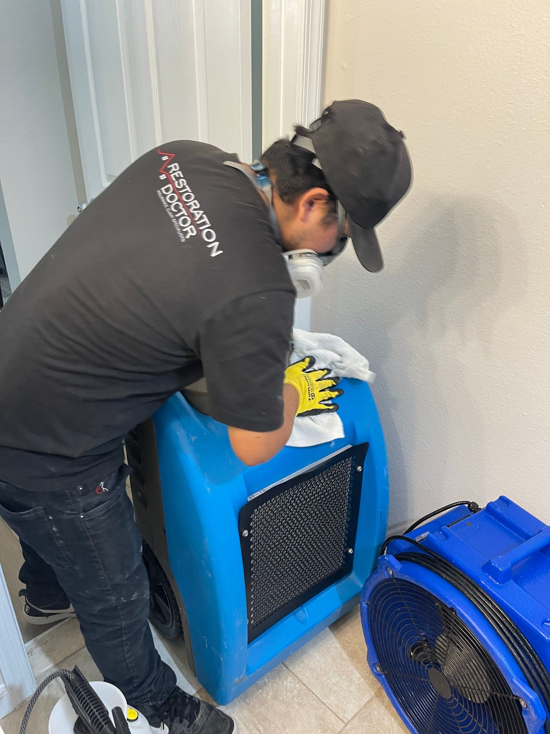 Dehumidification equipment positioned to manage moisture in water-damaged space.