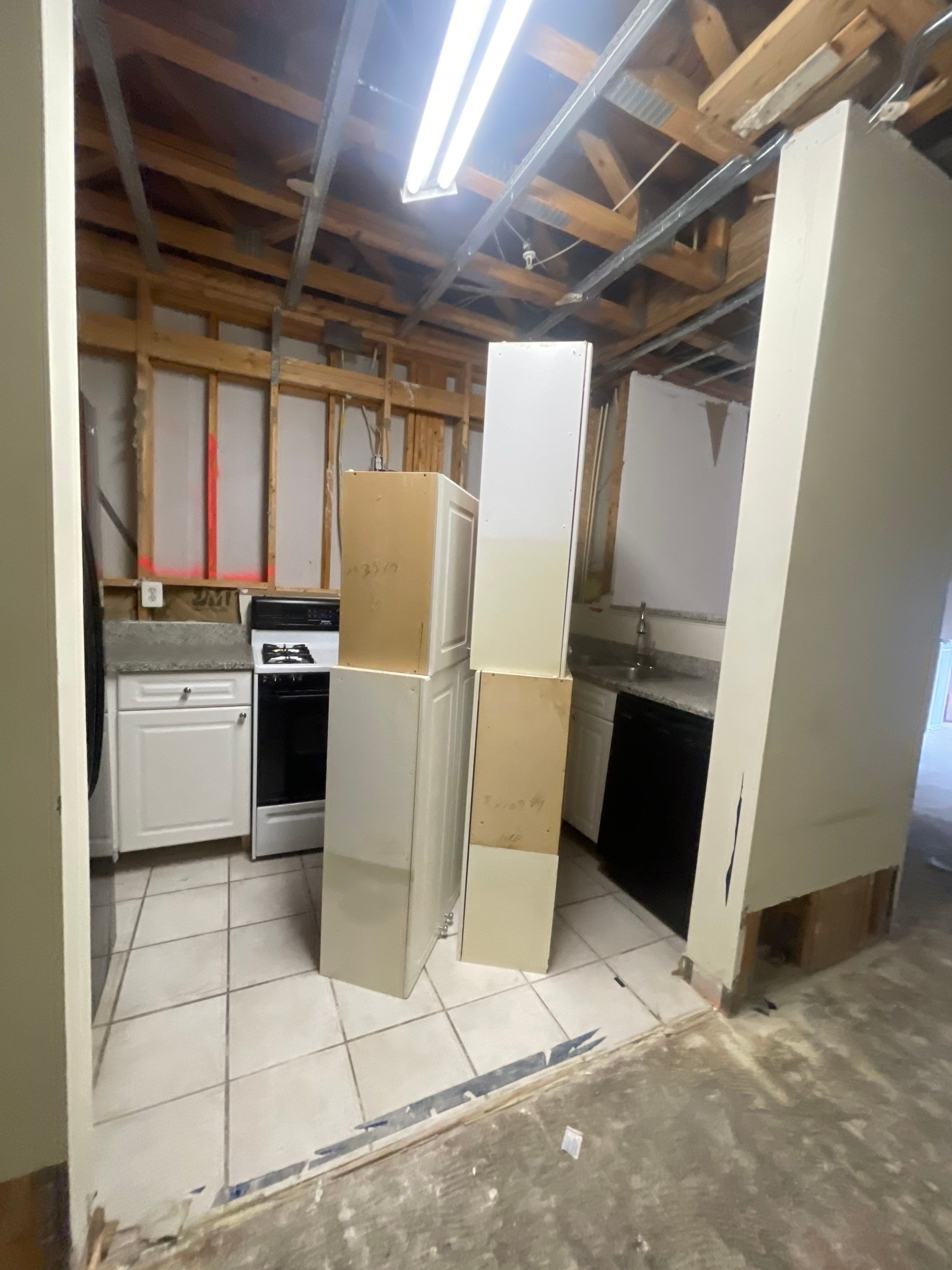 Mid-stage water restoration work in Vienna with dehumidifiers running and wall sections exposed for moisture removal.
