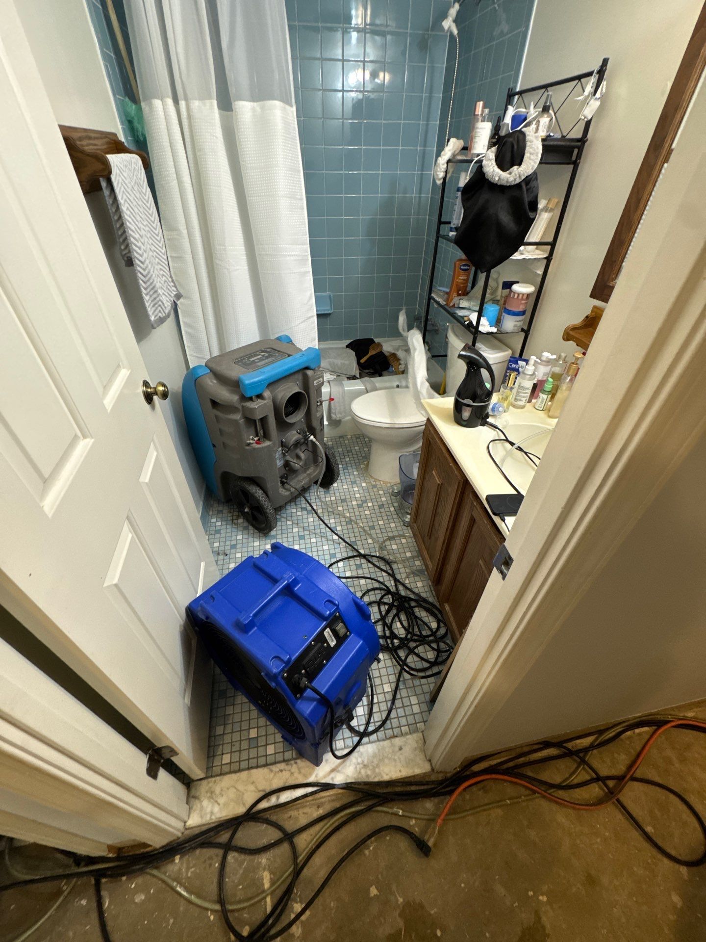 Negative air and dehumidification equipment operating within containment barrier.