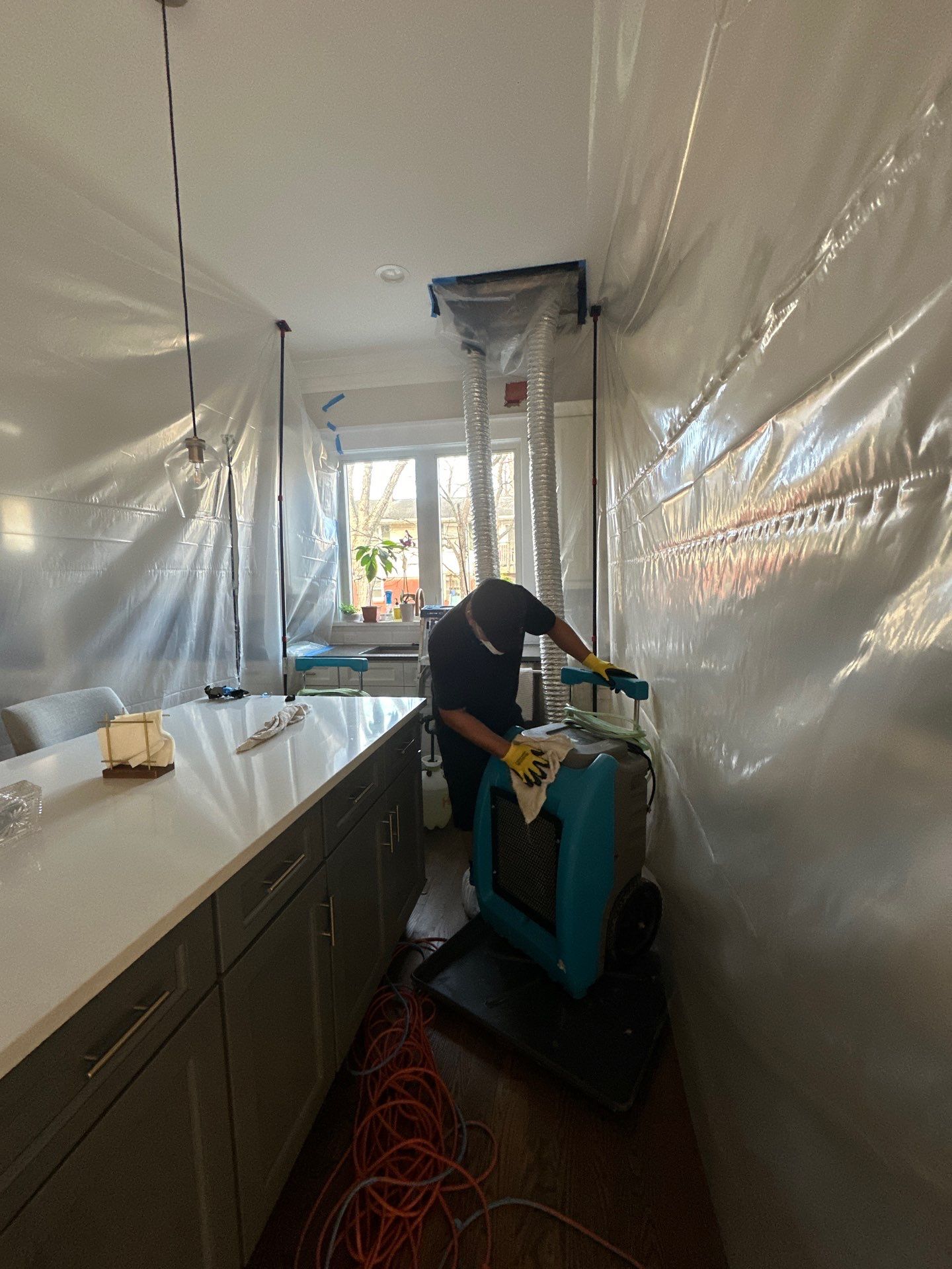 Dehumidification equipment operating during structural drying phase of restoration work.