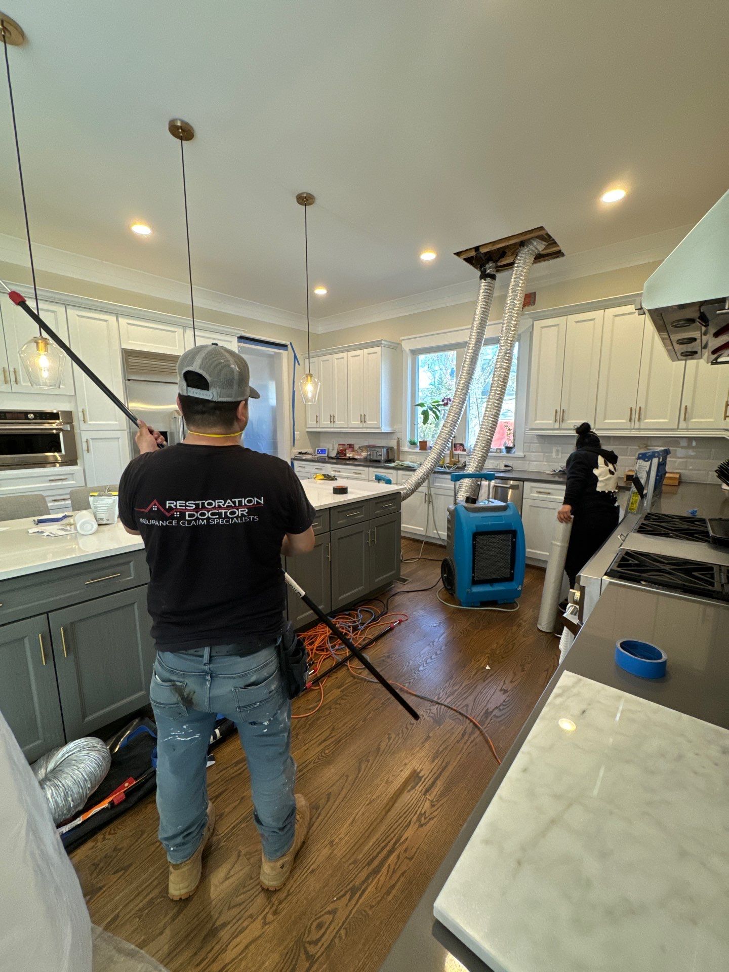 Final-stage water damage restoration in Vienna with containment barrier and drying equipment.