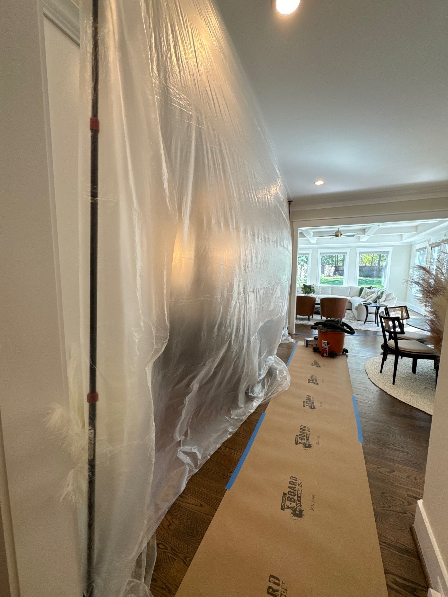 Structural drying in progress with dehumidifiers and air movers within containment zone.