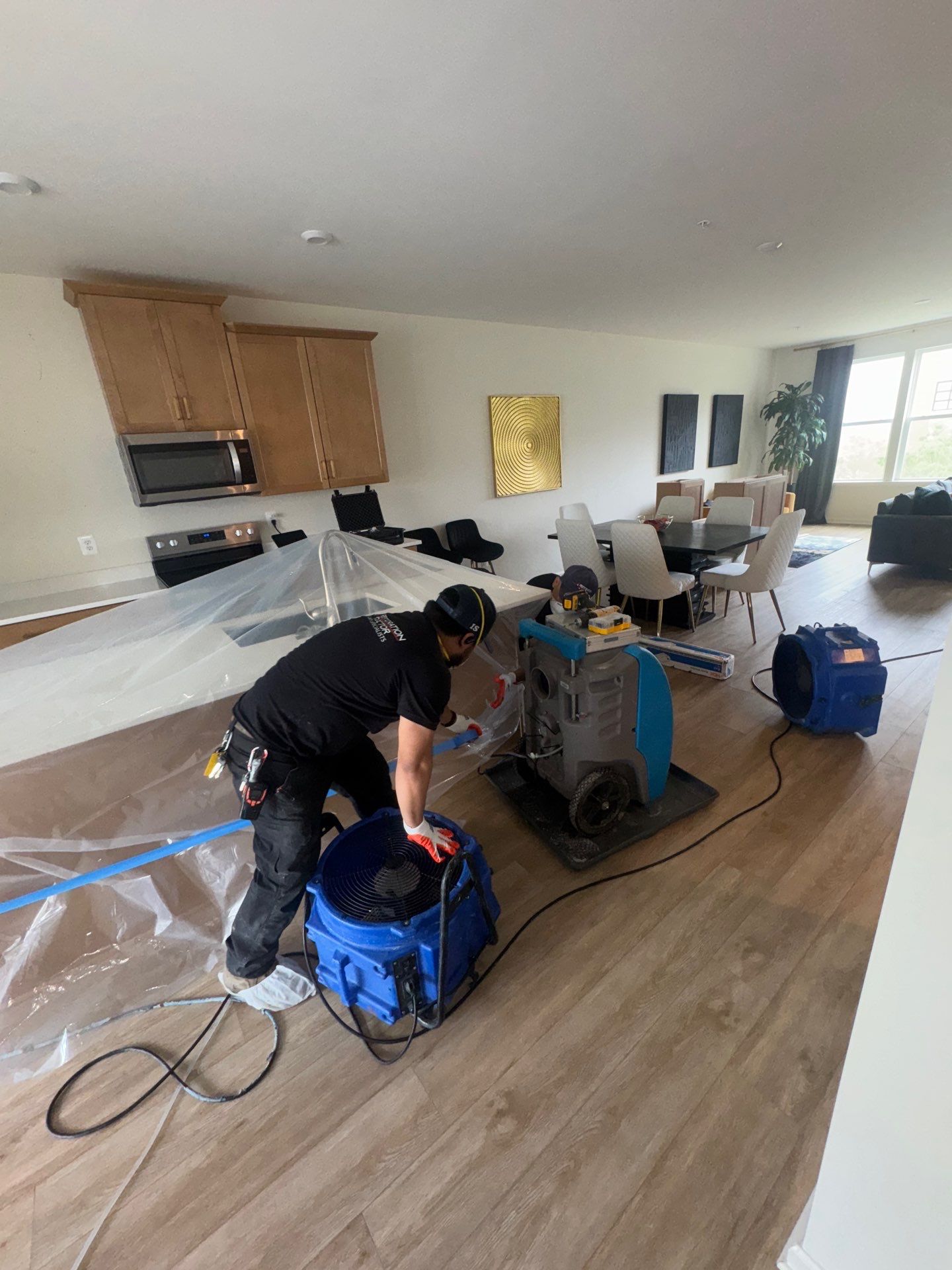 Structural drying phase with dehumidifiers and air movers positioned to manage moisture throughout affected spaces.