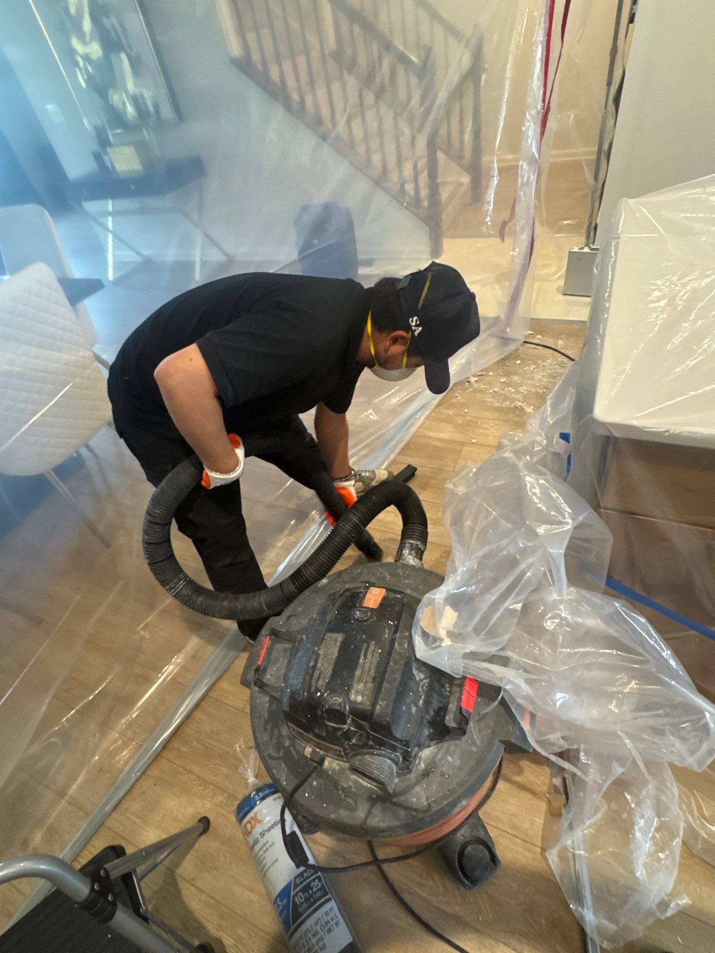 Standing water removal underway in Woodbridge water damage restoration, extractors deployed across flooded interior.