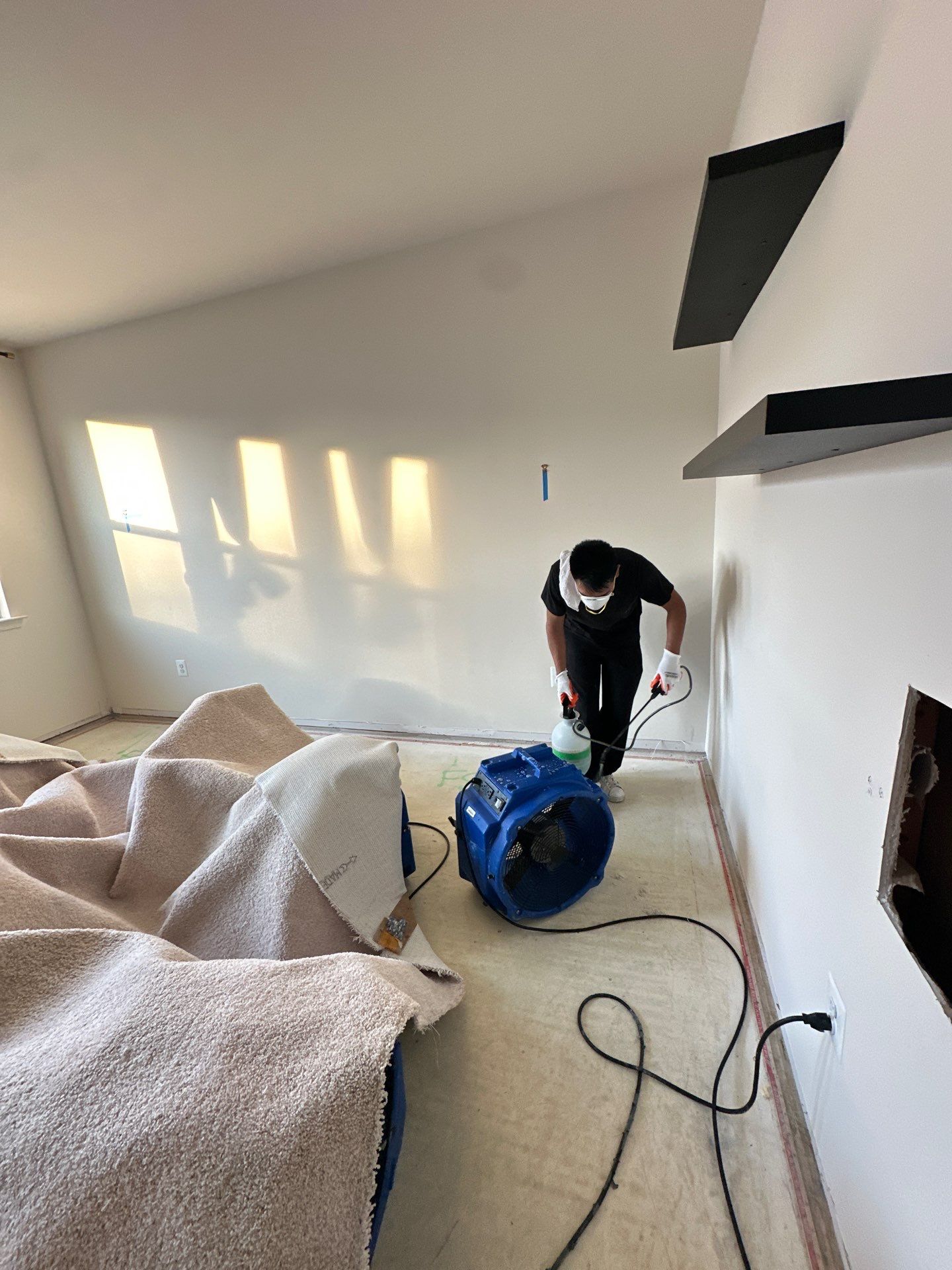 Drywall finishing underway with taping and joint compound application in restored wall sections.