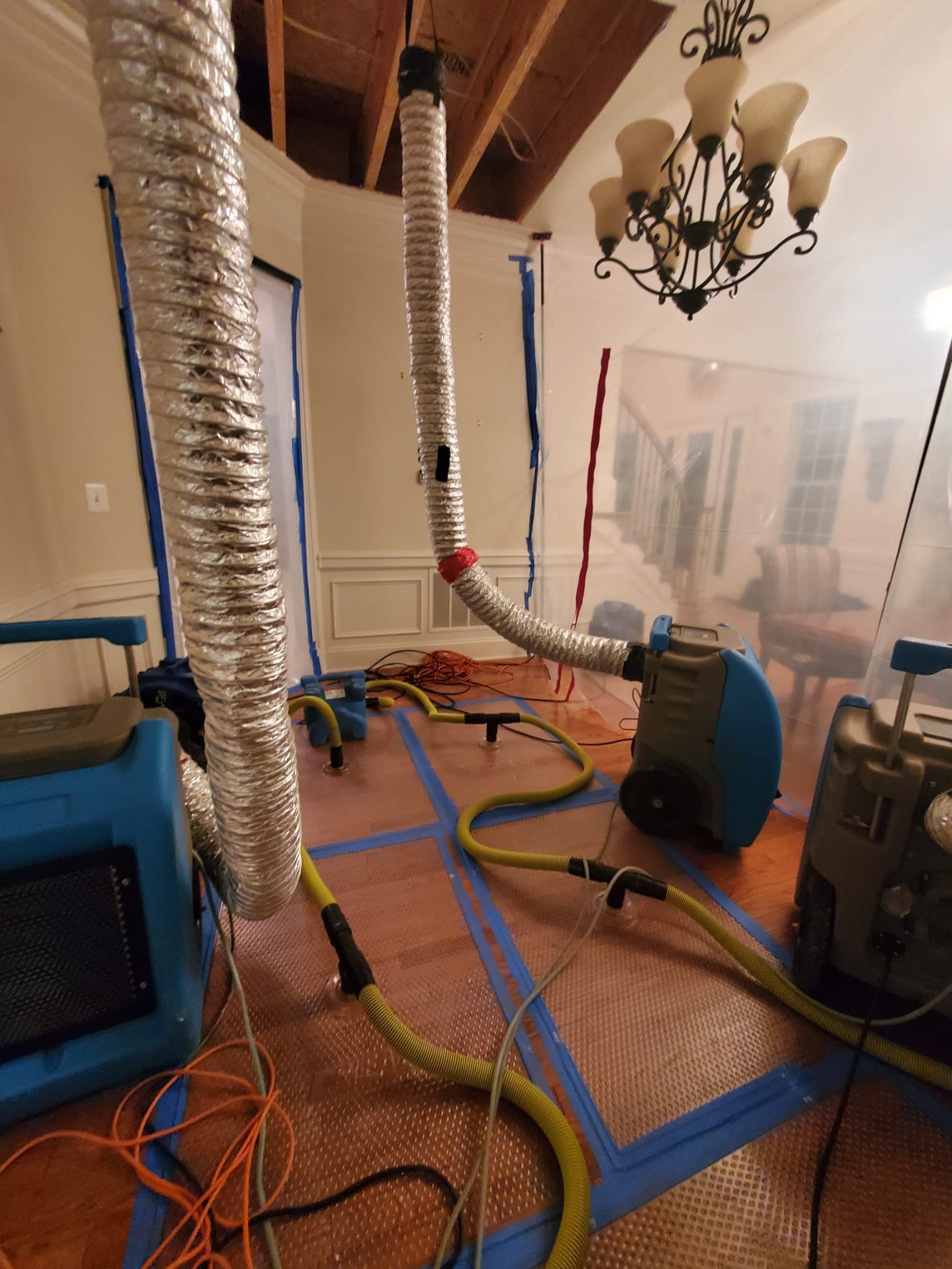 Water extraction equipment removing standing water from restoration area.