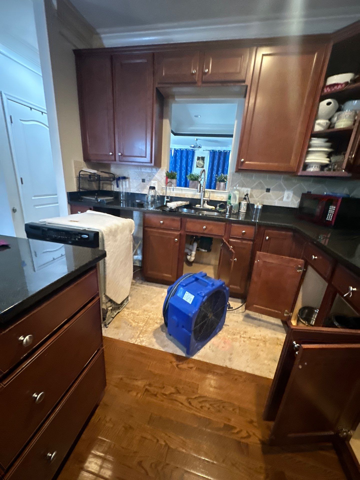 Dehumidifier and air movers deployed during water restoration to extract moisture from affected areas.