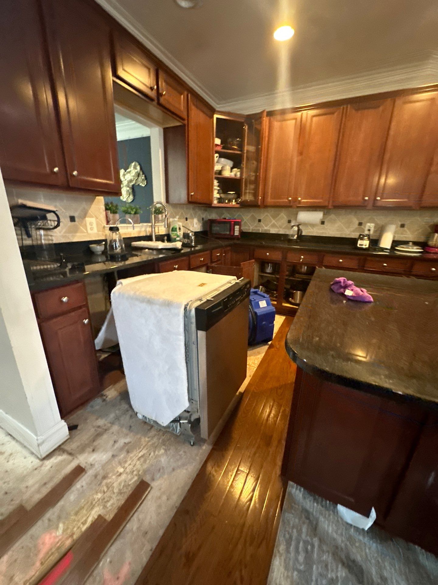 Water-damaged carpet and flooring in Aldie home with drying equipment positioned for structural moisture removal.