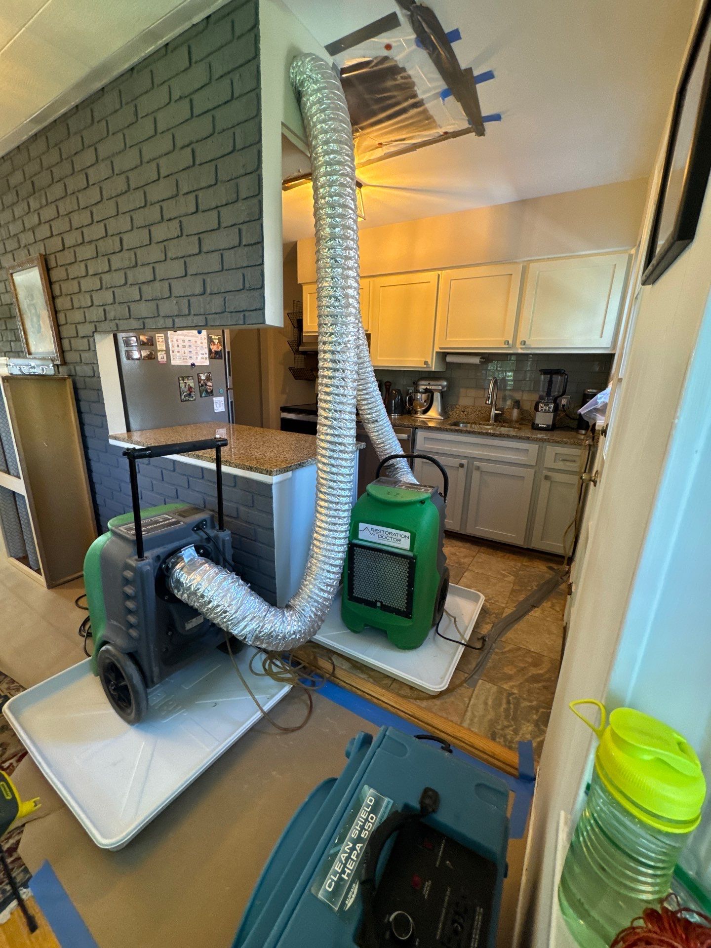 Structural drying equipment positioned to address moisture saturation from water intrusion in Arlington.