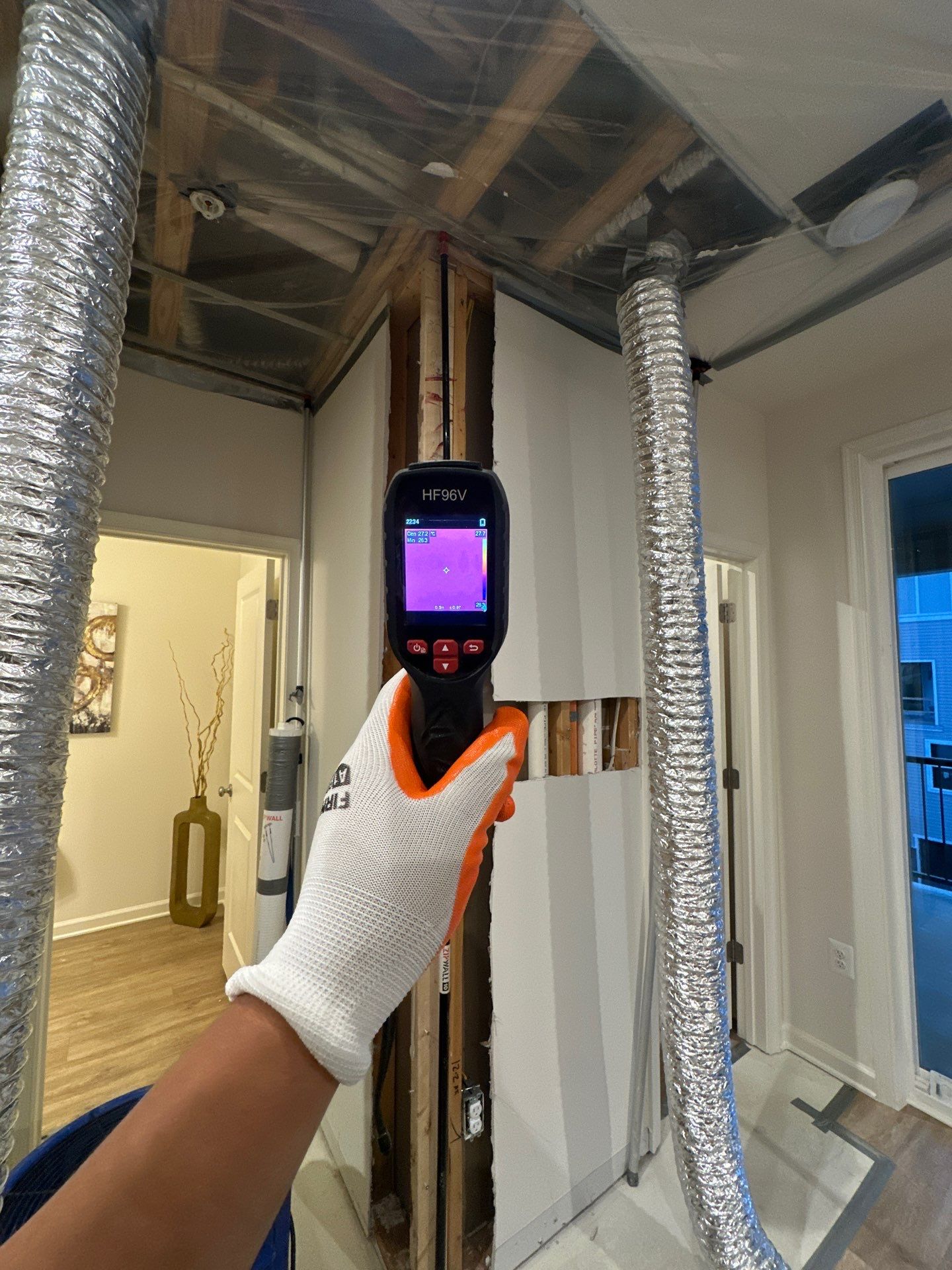 Thermal imaging camera documenting moisture distribution across ceiling framing during water damage assessment in Woodbridge.
