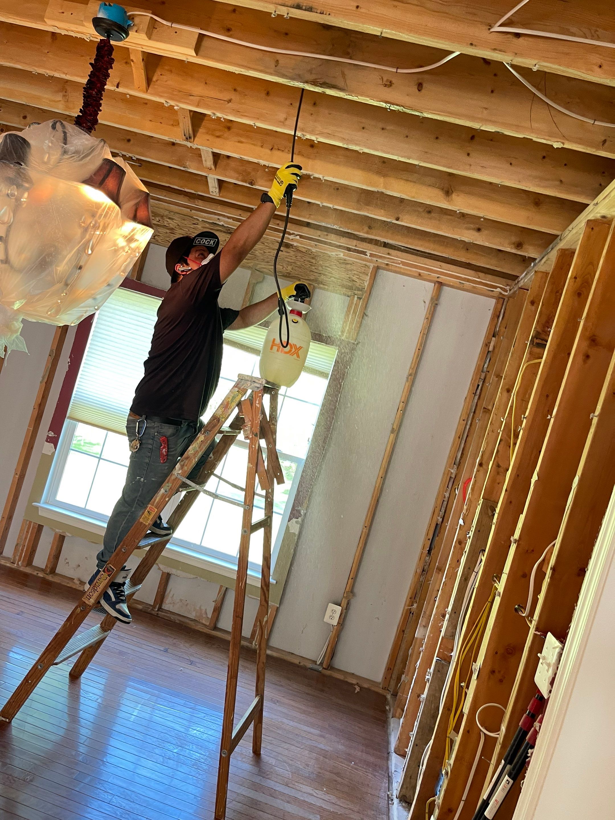 Containment and sanitizing phase of water damage restoration with protective barriers in place.
